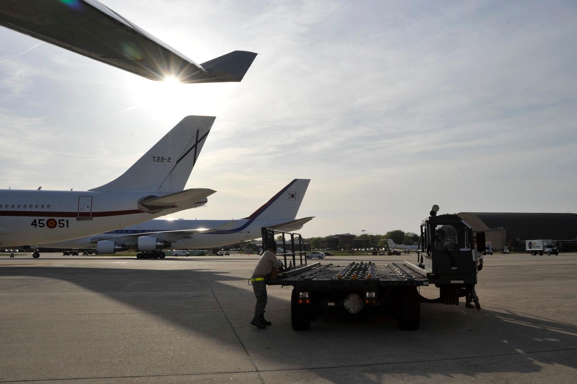 Airmen from 437th Aerial Port Squadron out of Charleston AFB, S.C., prepare to offload baggage from the Filipino President Gloria Macapagal-Arroyo's plane, April 12, 2010, at Joint Base Andrews, Md., in support of the Nuclear Security Summit hosted by President Barack Obama in Washington, D.C. The 316th Wing is leading operations to provide safe, effective, and efficient arrival and departure services for the invited guests transiting Andrews. (U.S. Air Force photo by Airman 1st Class Perry Aston) 