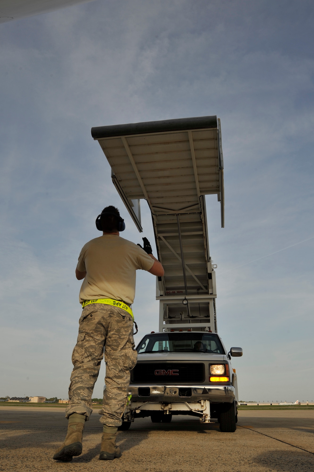 Senior Airman Brian Tater, 437th Aerial Port Squadron aerial port specialist, directs the stair truck to door of the Filipino President Gloria Macapagal-Arroyo's plane, April 12, 2010, at Joint Base Andrews, Md., in support of the Nuclear Security Summit hosted by President Barack Obama in Washington, D.C., this Monday and Tuesday. The 316th Wing is leading operations to provide safe, effective, and efficient arrival and departure services for the invited guests transiting Andrews. (U.S. Air Force photo by Airman 1st Class Perry Aston) (Released)