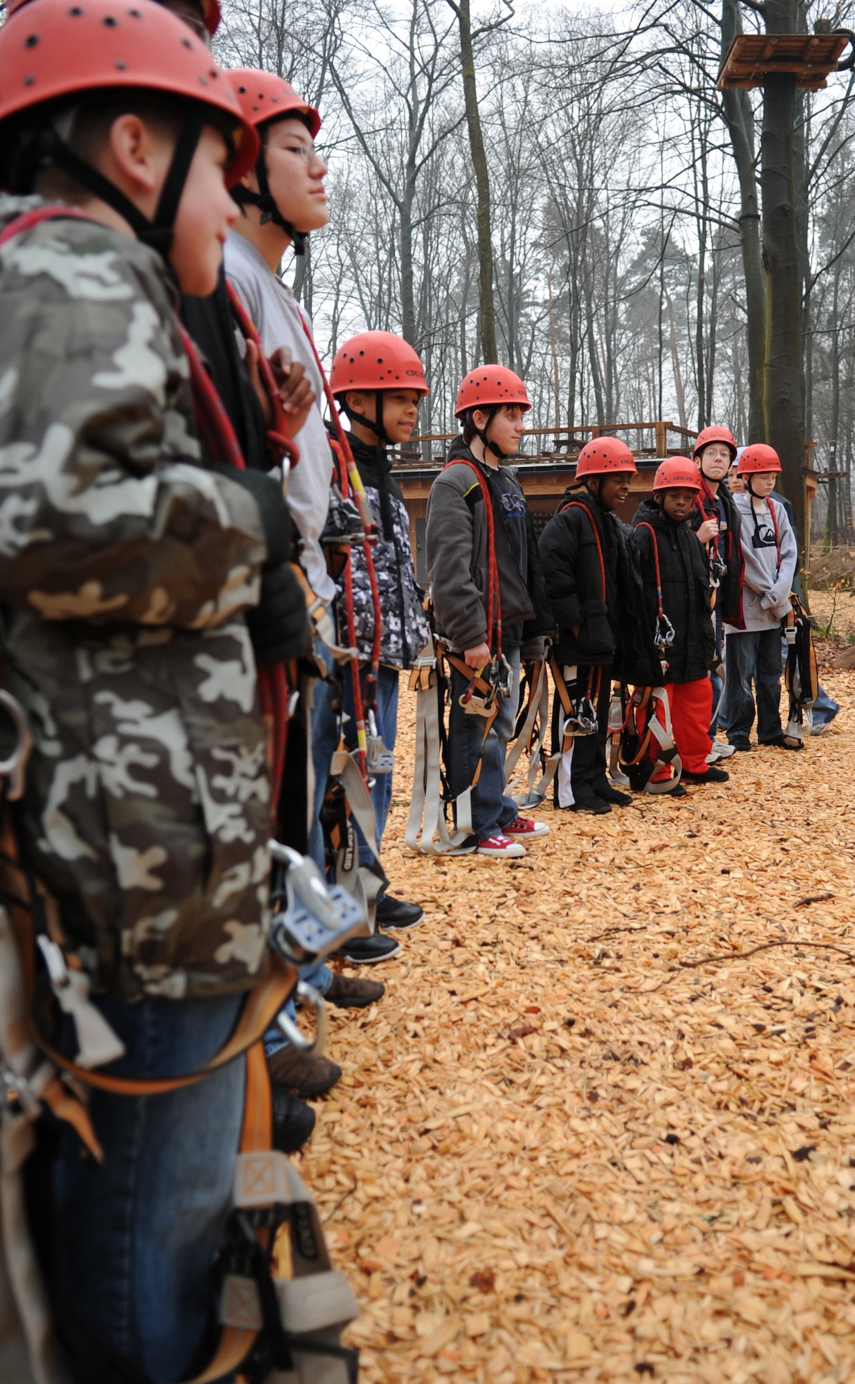 Children attending the Vogelweh Spring Break Outdoor Adventure Camp at K1 High Ropes Course Fröhnerhof, are shown how to put on their harnesses, Kaiserslautern, Germany, April 13, 2010.  Vogelweh Youth Center hosted the Vogelweh Spring Break Camps during a weeklong series of events for children ages 9-12 in the Kaiserslautern Military Community, consisting of Sports, Outdoor Adventure, The Arts, and Swimming Camps ending off with a movie day. (U.S. Air Force Photo by Airman 1st Class Caleb Pierce)