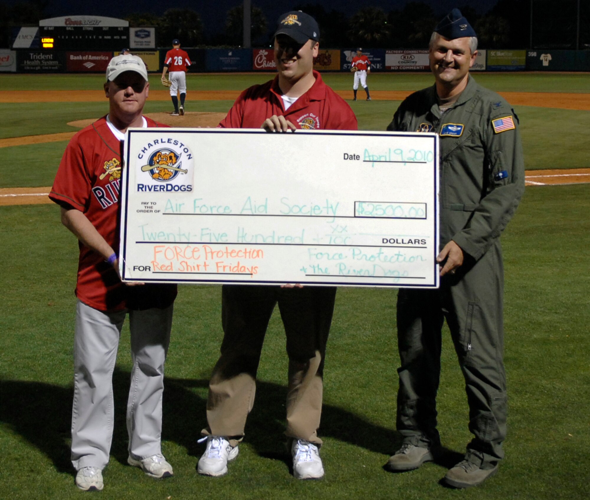 Col. Mike Speer, right, accepts a check for $2,500 from Jim Pfander and Tommy Pruitt, left, at a Charleston RiverDogs game April 9, 2010, at Joseph P. Riley Jr. Park in Charleston, S.C. The check was made out to the Air Force Aid Society from Force Protection, a manufacturer of blast- and ballistic-protected armored vehicles and other survivability products, and the Charleston RiverDogs baseball team in support of the annual Air Force Assistance Fund Campaign. Colonel Speer is the 315th Airlift Wing vice commander; Mr. Pruitt is the senior director of communications for Force Protection; and Mr. Pfander is the assistant general manager for the Charleston RiverDogs. (U.S. Air Force photo/Senior Airman Timothy Taylor)