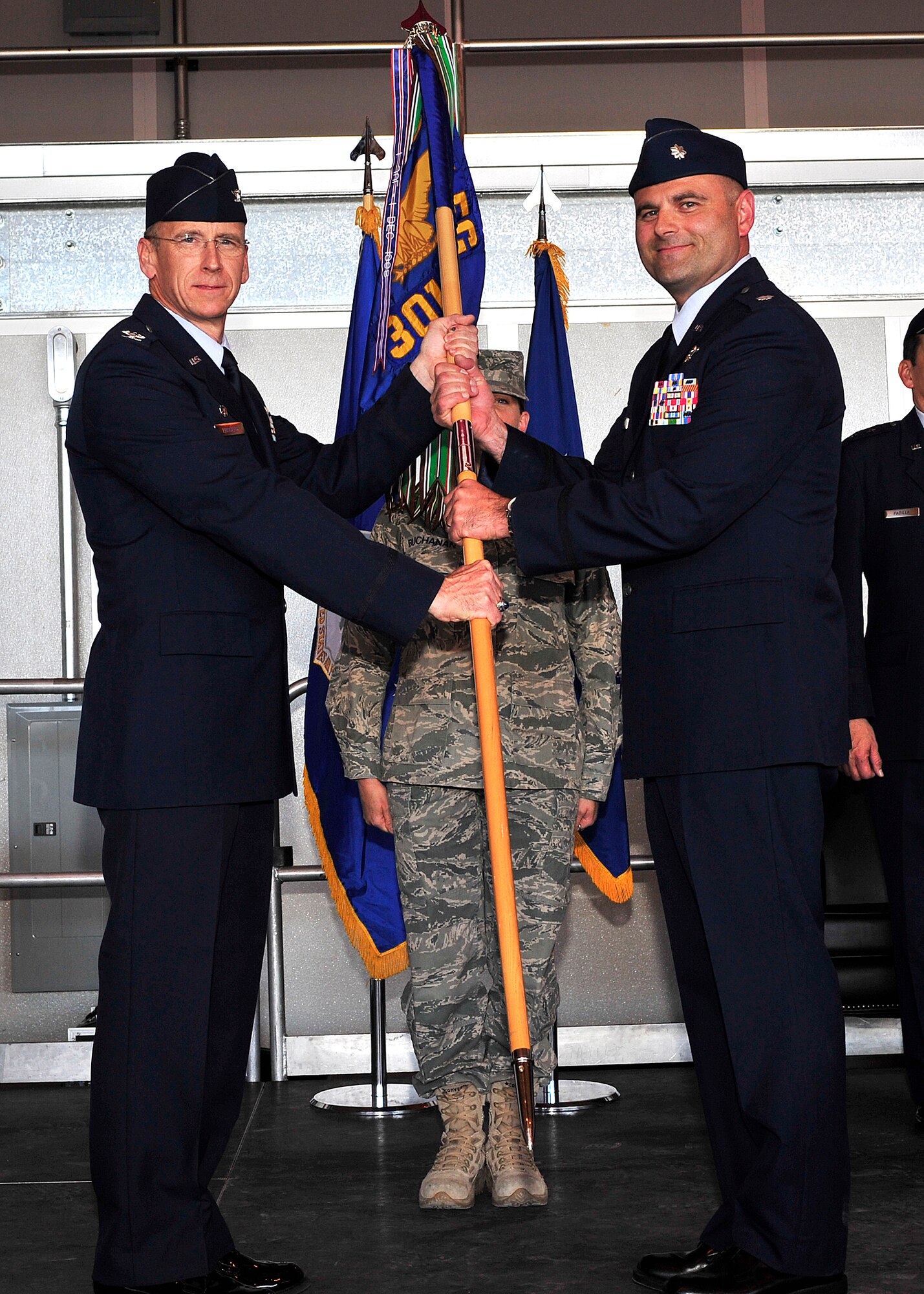 HOLLOMAN AIR FORCE BASE, N.M. -- Lt. Col. Kent Furman assumes command of the 301st Fighter Squadron from Col. Donald Lindberg, 44th Fighter Group commander, during an activation ceremony in Hangar 877 April 9, 2010.  The 301st was one of four African-American fighter squadrons to enter combat during World War II and was known as the "Red Tail Angels". The Tuskegee Airman of the 301st FS saw combat in the European Theater of Operations and Mediterranean Theater of Operations from February 1944 to April 1945. (U.S. Air Force photo by Senior Airman DeAndre Curtiss / Released)