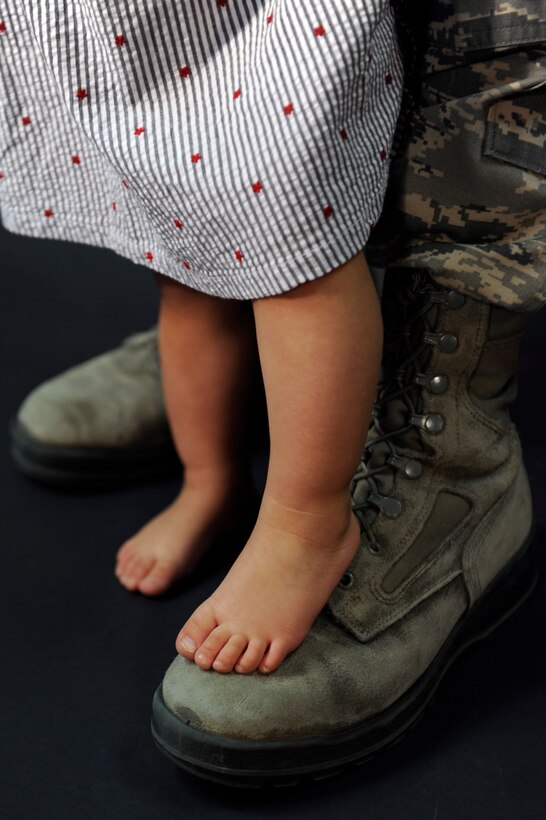 ELLSWORTH AIR FORCE BASE S.D. -- An Ellsworth Airman and his daughter stand together April 8.   April has been designated as the Month of the Military Child.  "The children of our military families serve in their own way," said Col. Jeffrey Taliaferro, 28th Bomb Wing commander. "We cannot forget how they quietly sacrifice, and do without for the sake of the Nation." (U.S. Air Force photo/Senior Airman Marc I. Lane)