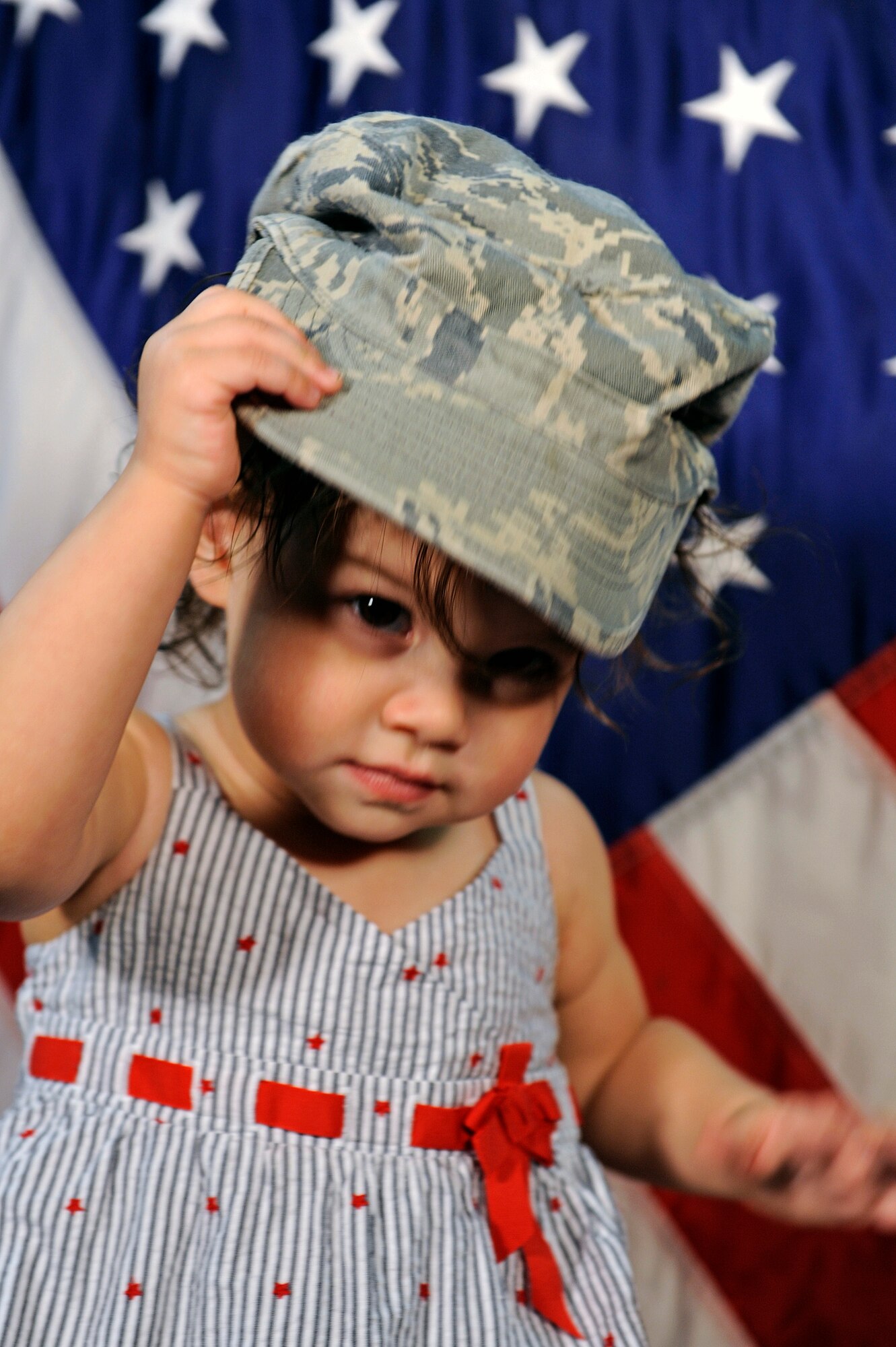 ELLSWORTH AIR FORCE BASE S.D. -- The daughter of an Ellsworth Airman wears her father’s hat, April 8.  April has been designated as the Month of the Military Child to emphasize the important role children play in the Armed Forces community. (U.S. Air Force photo/Senior Airman Marc I. Lane)