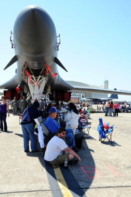 Attendees seek shade underneath the nose of a B-1 Lancer at the 75th Anniversary Air Show April 11. More than 125,000 were in attendance during the air show April 10-11, enjoying a variety of aerial performances and static displays. This was Eglin’s first open house since 2007 and was timed to coincide with the 75th anniversary of the installation. The F-22A Raptor demo, Army Black Daggers and "Tora, Tora, Tora" were some of the highlights of the event. (U.S. Air Force photo/ Samuel King Jr.)