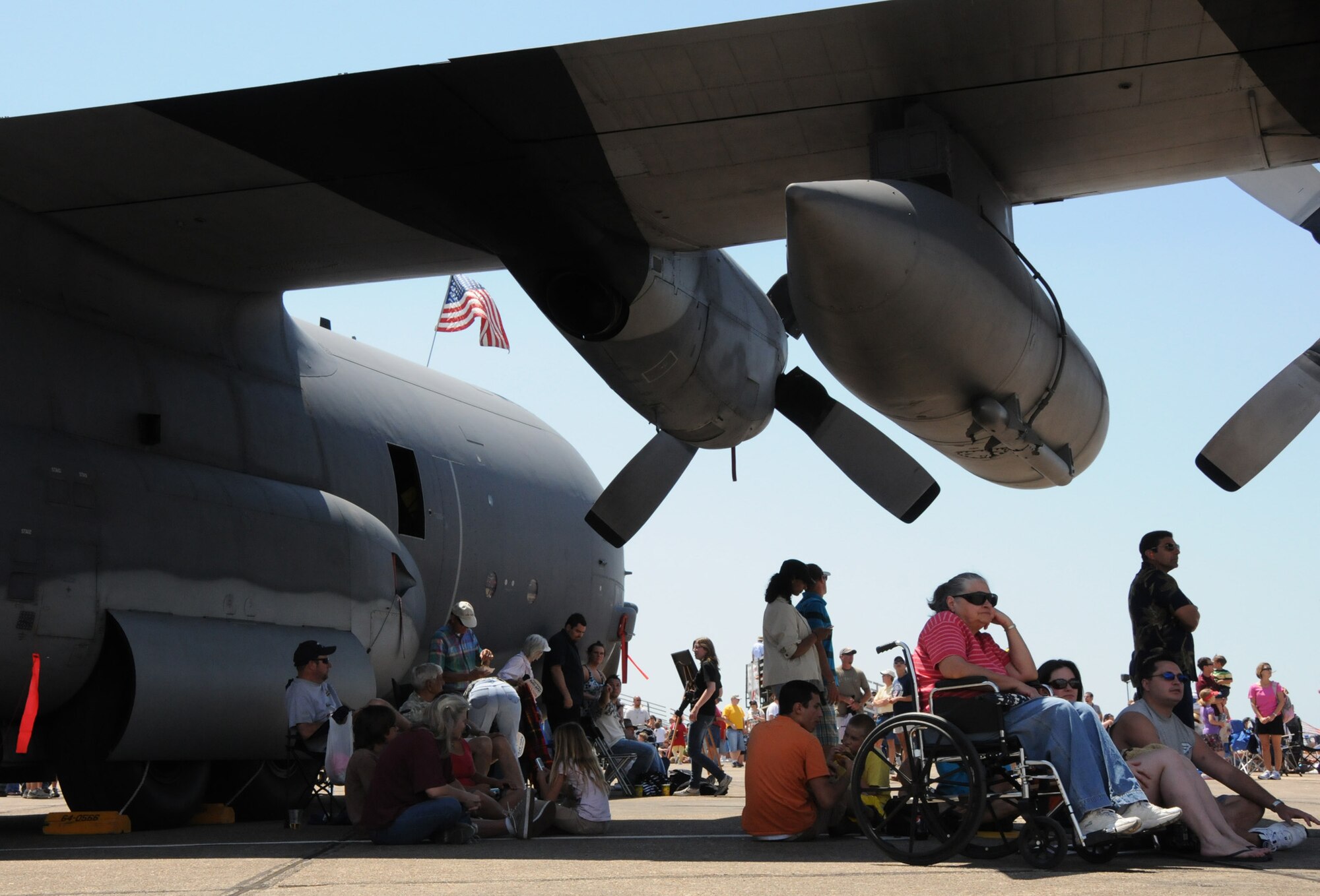 Attendees seek shade underneath a 919th Special Operations Wing C-130 at the 75th Anniversary Air Show April 11. More than 125,000 were in attendance during the air show April 10-11, enjoying a variety of aerial performances and static displays. This was Eglin’s first open house since 2007 and was timed to coincide with the 75th anniversary of the installation. The F-22A Raptor demo, Army Black Daggers and "Tora, Tora, Tora" were some of the highlights of the event. (U.S. Air Force photo/ Samuel King Jr.)