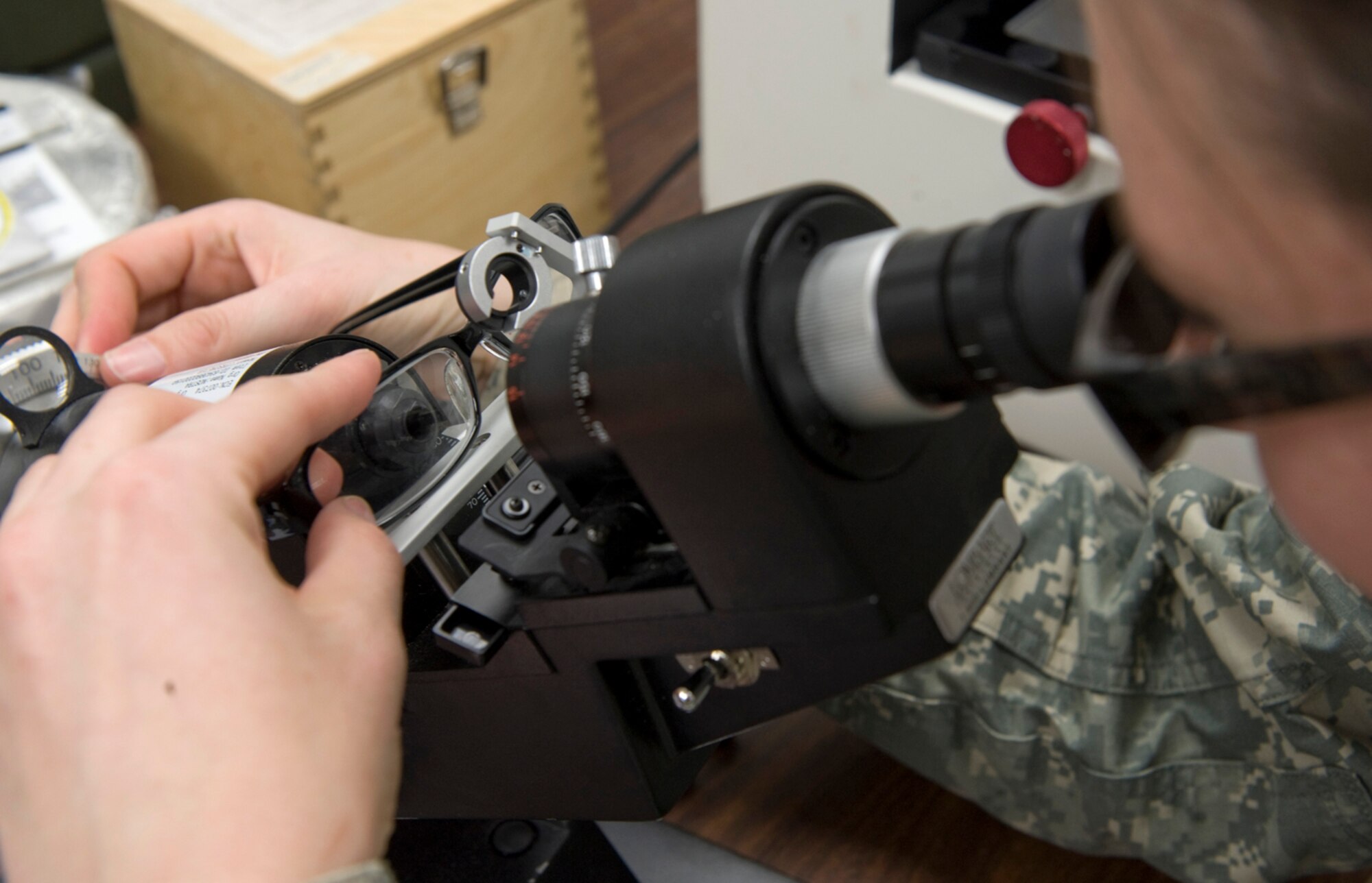 Army Spc. Alisha Weatherby inspects a new pair of eyeglasses during Operation Arctic Care April 12, 2010, in Kotzebue, Alaska. Specialist Weatherby is an optical lab specialist from the Naval Ophthalmic Support and Training Activity in Yorktown, Va. (U.S. Air Force photo/Master Sgt. Jack Braden)