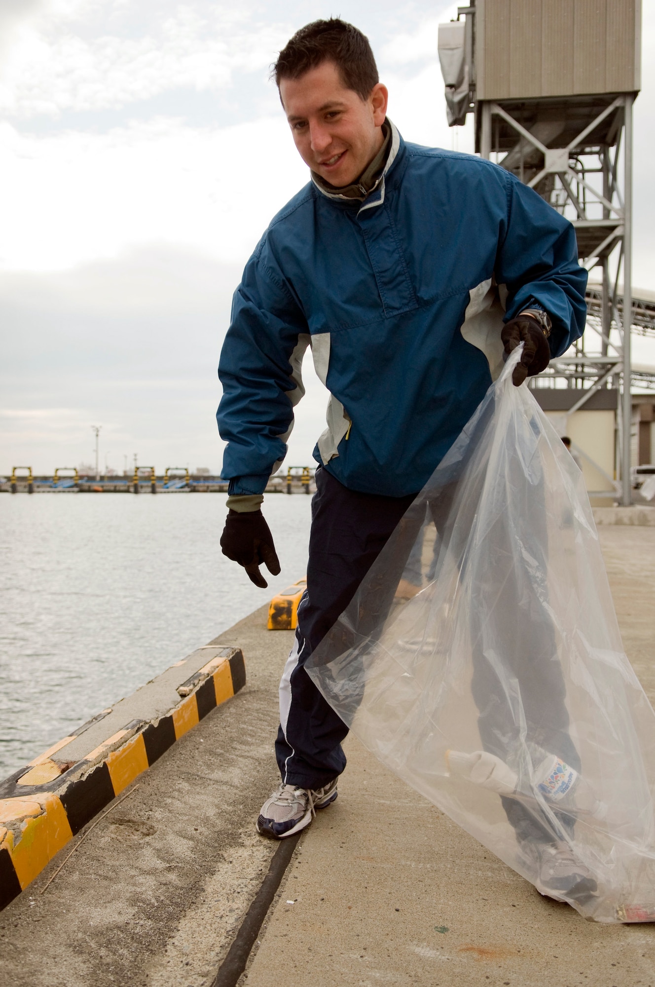 Capt. Mario Tellez scans the area for trash along the Misawa port and beach, April 10, 2010, at Misawa Air Base, Japan. Captain Tellez is the 35th Civil Engineer Squadron Readiness and Emergency Management flight commander. (U.S. Air Force photo/Senior Airman Jessica Lockoski)