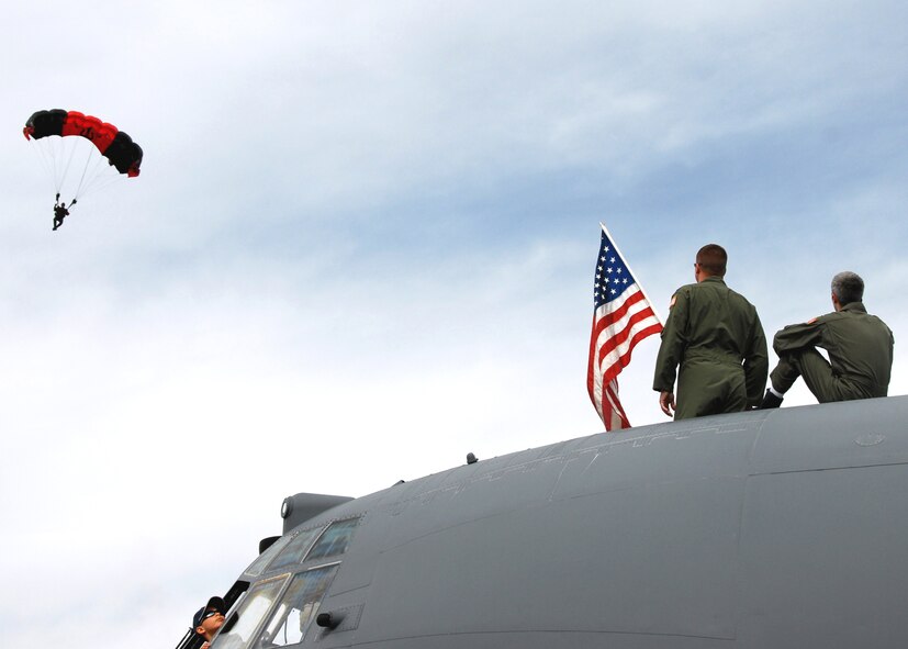 Aircrew members of the 919th Special Operations Wing watch as a jumper from the Army Black Daggers glides in to a landing at the Eglin 75th Anniversary Air Show April 10. More than 125,000 were in attendance for the show April 10-11, enjoying a variety of aerial performances and static displays. This was Eglin’s first open house since 2007 and was timed to coincide with the 75th anniversary of the installation. The Thunderbirds, Army Black Daggers, an F-22A Raptor demo and "Tora, Tora, Tora" were some of the highlights of the event. (U.S. Air Force photo/Airman 1st Class Anthony Jennings.) 
 
