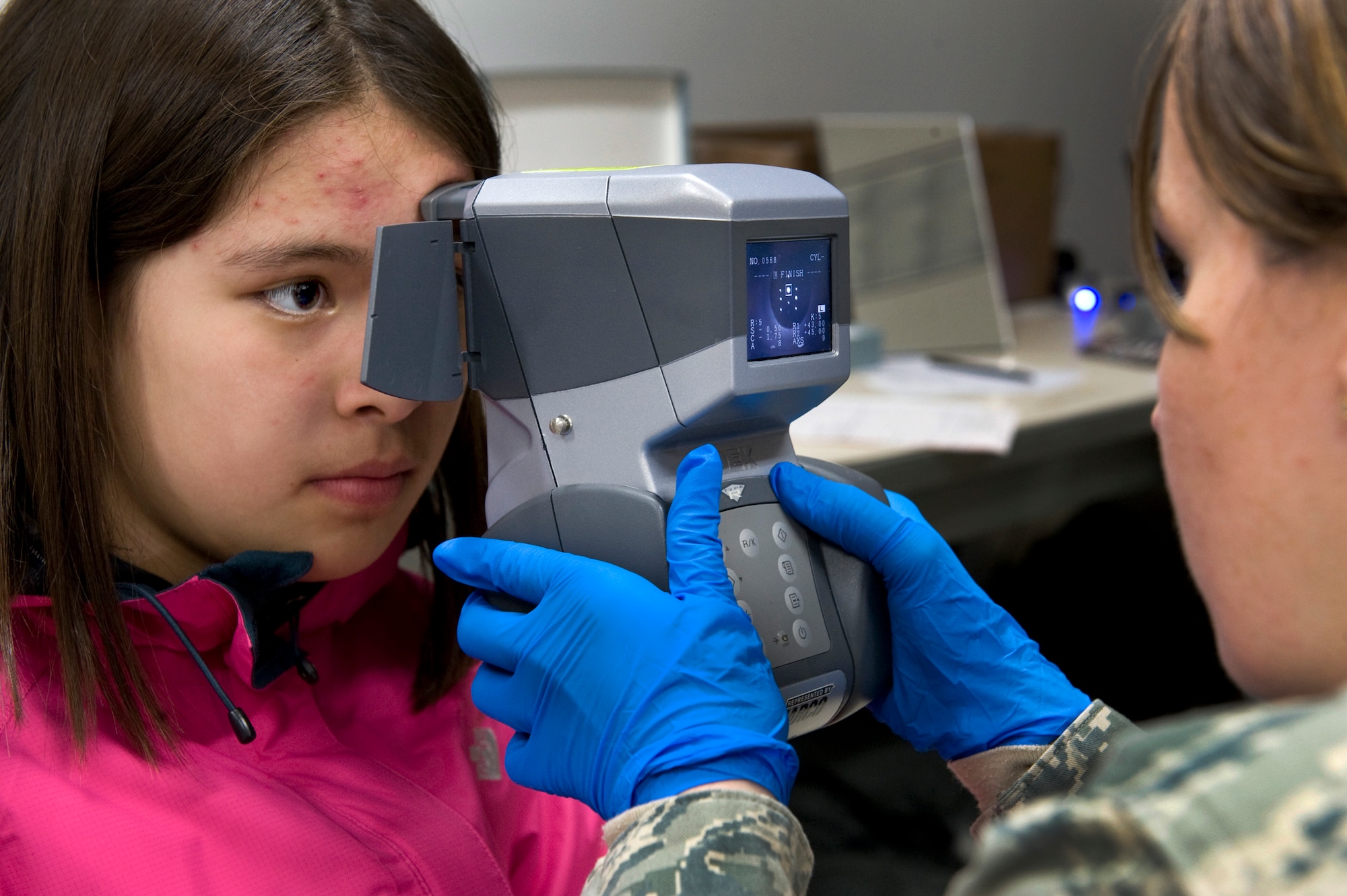 Tech. Sgt. Christy Shortridge uses an auto refractor to determine the eye-glass prescription for 11-year-old Zara Norton during Operation Arctic Care April 12, 2010, in Kotzebue, Alaska. Sergeant Shortridge is an ophthalmic technician deployed from the 440th Medical Squadron at Pope Air Force Base, N.C. (U.S. Air Force photo/Master Sgt. Jack Braden)