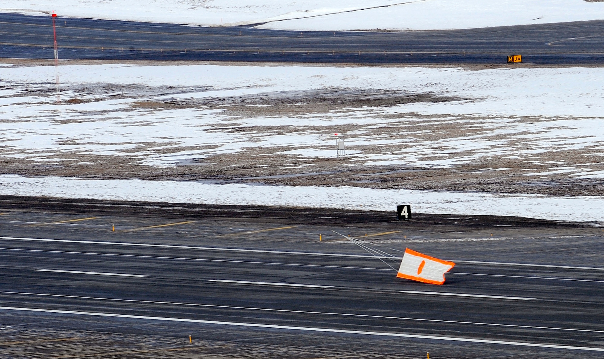 An air-to-air gunnery target banner lifts off the runway prior to a live fire training mission over an Alaskan range April 7, 2010, at Elmendorf Air Force Base, Alaska. The air-to-air gun mission consisted of a Cessna Conquest towing an aerial banner 2,000 feet behind it while two F-15 Eagles took turns firing at the banner. (U.S. Air Force photo/Staff Sgt. Brian Ferguson)