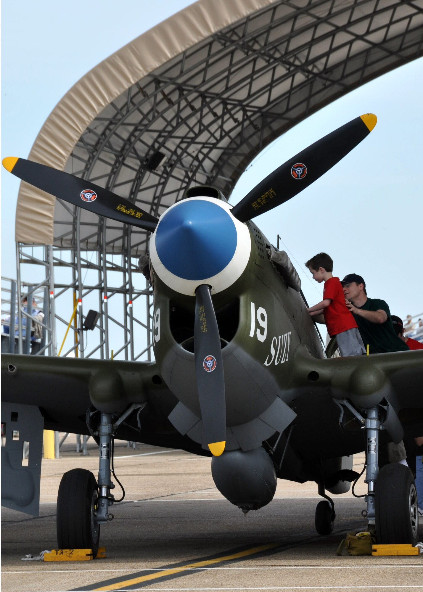 A father and son check out one of the vintage World War II aircraft on display April 10 at the Eglin 75th Anniversary Air Show. More than 125,000 were in attendance for the show April 10-11, enjoying a variety of aerial performances and static displays. This was Eglin’s first open house since 2007 and was timed to coincide with the 75th anniversary of the installation. The Thunderbirds, Army Black Daggers, an F-22A Raptor demo and "Tora, Tora, Tora" were some of the highlights of the event. (U.S. Air Force photo/Airman 1st Class Rachelle Elsea.)