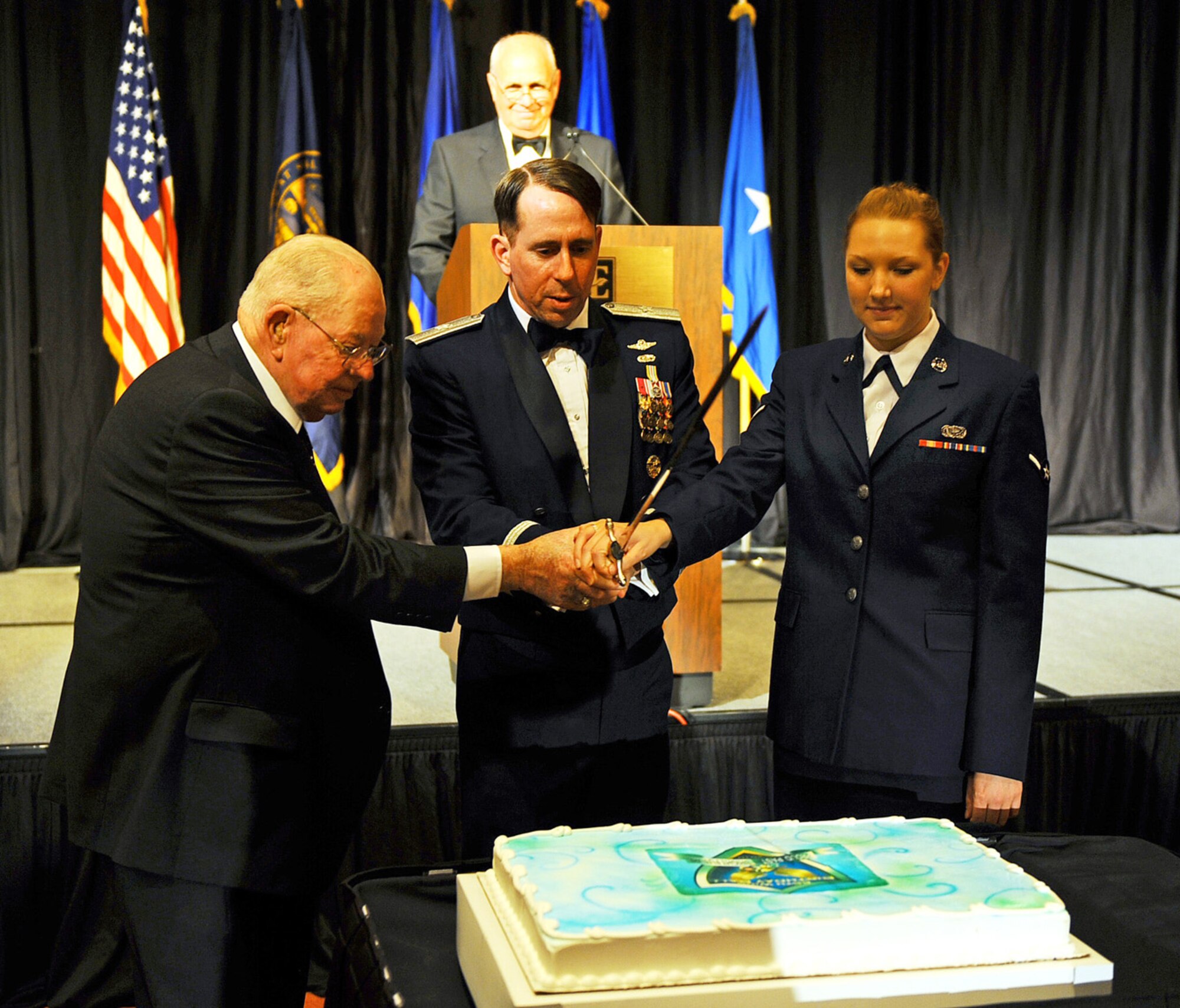 OFFUTT AIR FORCE BASE, Neb. ? Mr. Don Gifford, (left) a former P-51 pilot with the 55th Fighter Group, Brig. Gen. John N.T. Shanahan, (center) the 55th Wing commander and the newest member of the 55th Wing Airman Kayla Hubbell, (right) assigned to the 55th Force Support Squadron, perform the ceremonial cutting of the cake during the 2010 55th Wing Birthday Ball at Embassy Suites in La Vista, Neb., April 10. More than 800 members of Team Offutt attended the event to honor the wing?s past and celebrate the current role of the Fightin? Fifty-Fifth in today?s Air Force. U.S. Air Force photo by Josh Plueger
