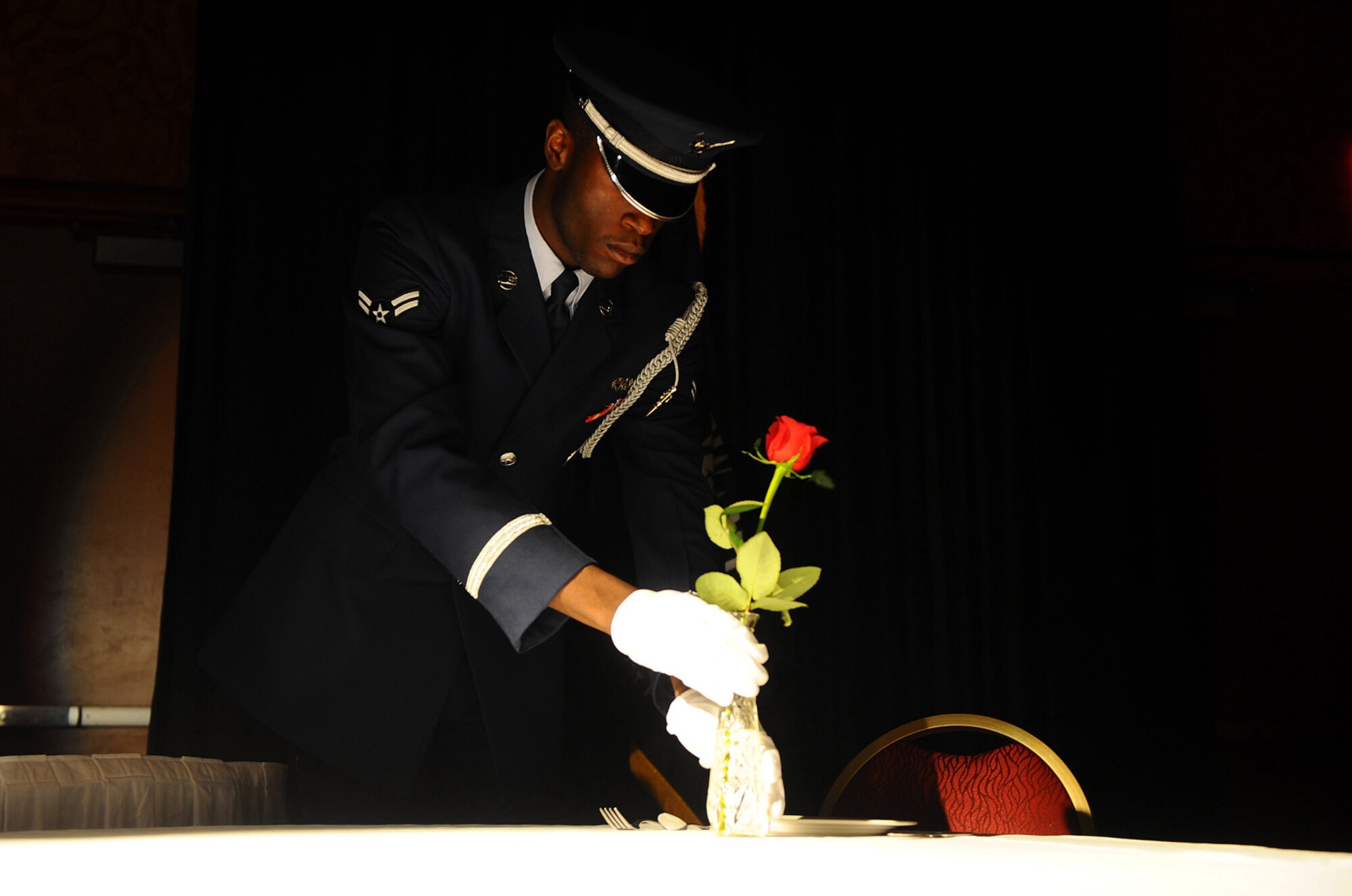 OFFUTT AIR FORCE BASE, Neb. ? Airman 1st Class Cameron T. Spencer, 55th Wing Honor Guard, places a rose into a vase on the Prisoners of War table during the 2010 55th Wing Birthday Ball at Embassy Suites in La Vista, Neb., April 10. The placing of the rose symbolizes the hope that families and loved ones have for the safe return of servicemembers who are POWs or missing in action. More than 800 members of Team Offutt attended the ball to honor the wing?s past and celebrate the current role of the Fightin Fifty-Fifth in today?s Air Force. U.S. Air Force photo by Josh Plueger

