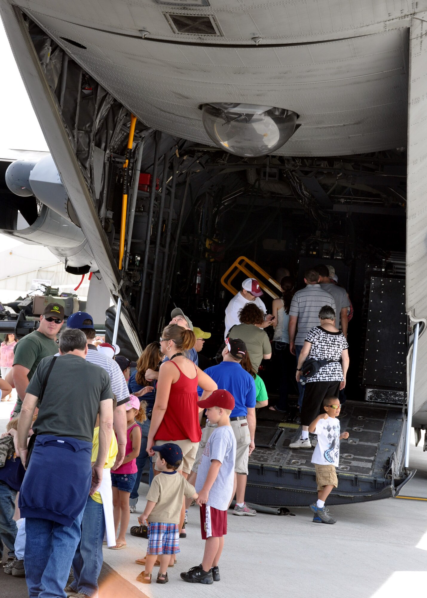 People wait to go inside a C-130 April 10 at the Eglin 75th Anniversary Air Show. More than 125,000 were in attendance for the show April 10-11, enjoying a variety of aerial performances and static displays. This was Eglin’s first open house since 2007 and was timed to coincide with the 75th anniversary of the installation. The Thunderbirds, Army Black Daggers, an F-22A Raptor demo and "Tora, Tora, Tora" were some of the highlights of the event. (U.S. Air Force photo/Airman 1st Class Rachelle Elsea.)