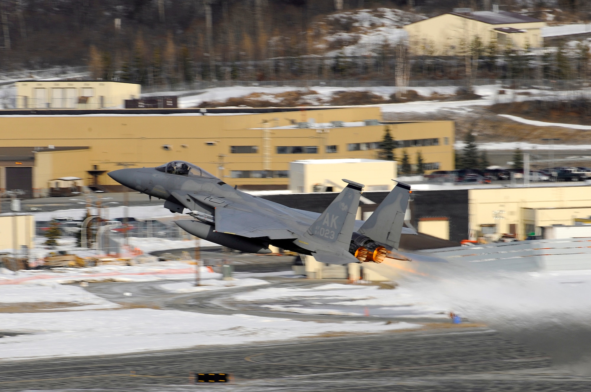 An F-15 Eagle takes off prior to a live fire training mission over an Alaskan range April 7, 2010, at Elmendorf Air Force Base, Alaska. The air-to-air gun mission consisted of a Cessna Conquest towing an aerial banner 2,000 feet behind it while two F-15 Eagles took turns firing at the banner. (U.S. Air Force photo/Staff Sgt. Brian Ferguson)