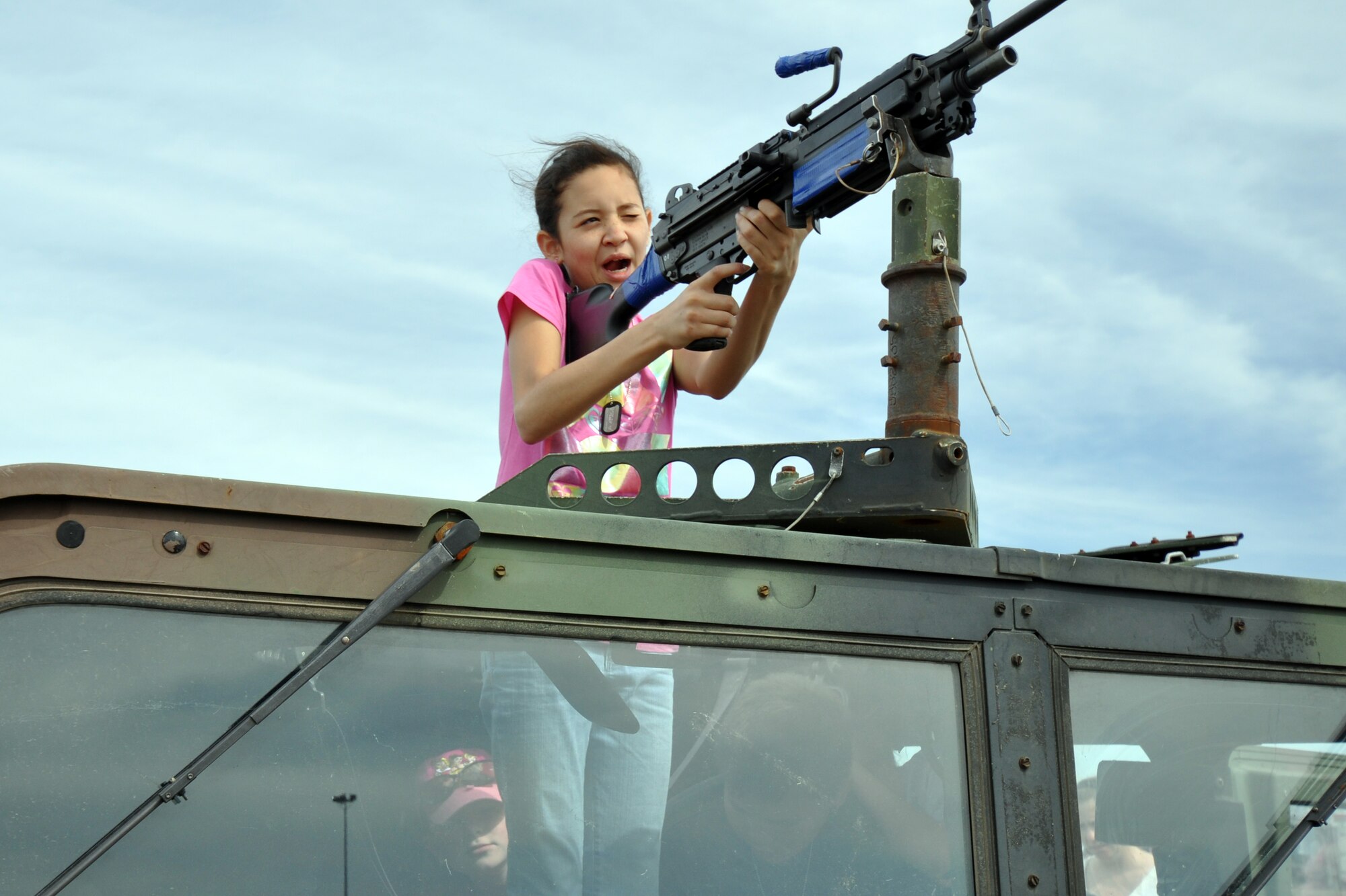 A future-recruit takes aim with the 50-caliber turret on top of a Humvee on display at the Eglin 75th Anniversary Air Show April 10. More than 125,000 were in attendance for the show April 10-11, enjoying a variety of aerial performances and static displays. This was Eglin’s first open house since 2007 and was timed to coincide with the 75th anniversary of the installation. The Thunderbirds, Army Black Daggers, an F-22A Raptor demo and "Tora, Tora, Tora" were some of the highlights of the event. (U.S. Air Force photo/Airman 1st Class Anthony Jennings.)