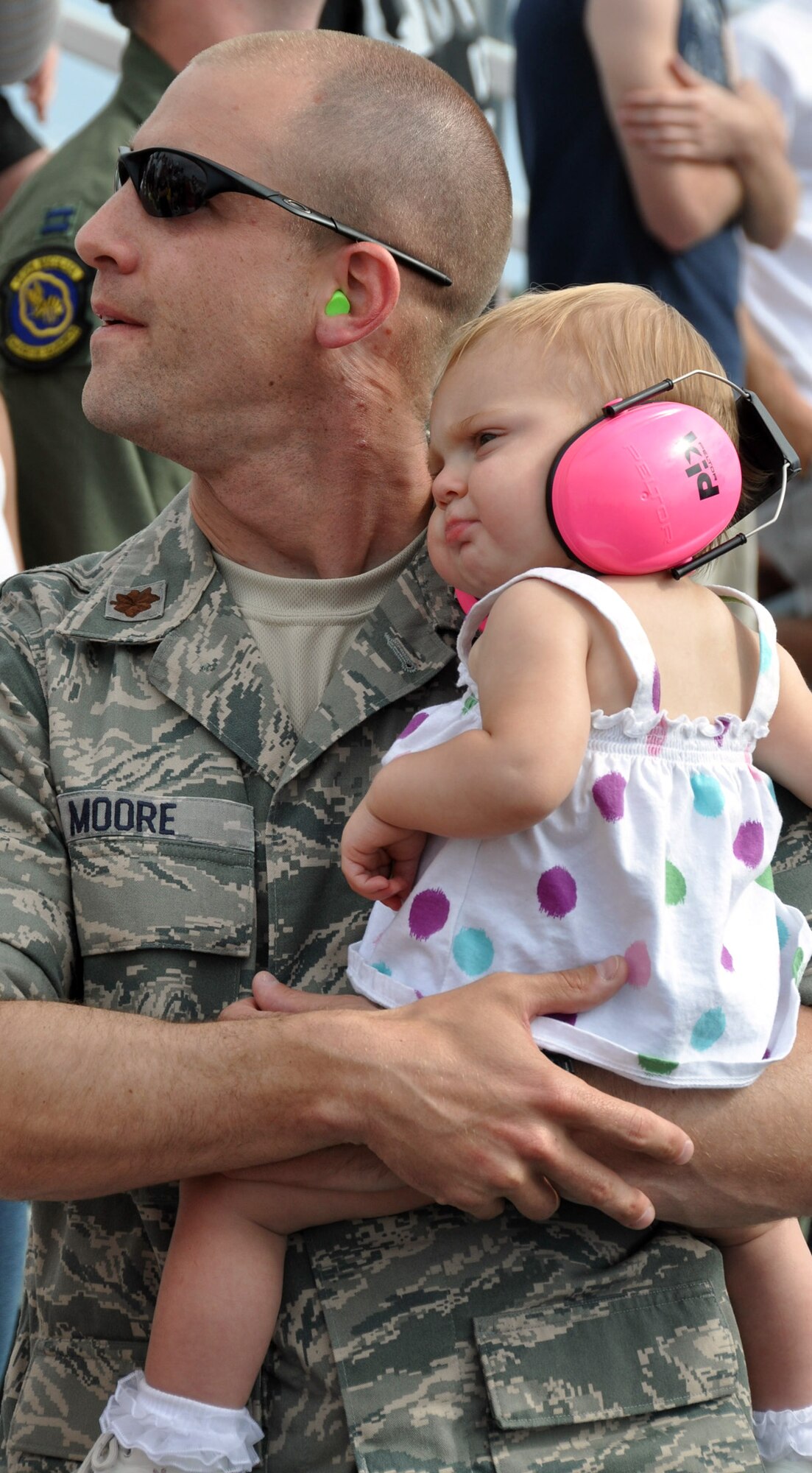 A major and his daughter watch for the Thunderbirds to come roaring past at Eglin's 75th Anniversary Air Show April 10. More than 125,000 were in attended April 10-11, enjoying a variety of aerial performances and static displays. This was Eglin’s first open house since 2007 and was timed to coincide with the 75th anniversary of the installation. The Thunderbirds, Army Black Daggers, an F-22A Raptor demo and "Tora, Tora, Tora" were some of the highlights of the event. (U.S. Air Force photo/Airman 1st Class Rachelle Elsea.) 