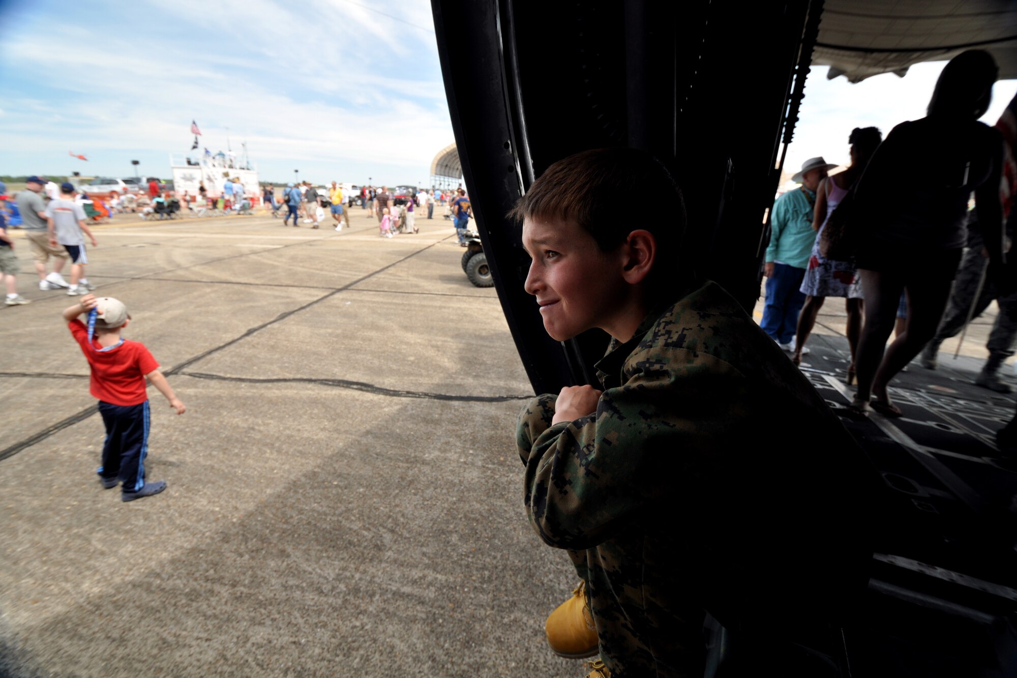 A future-recruit looks of the door of one of the C-130s on display at the Eglin 75th Anniversary Air Show April 10.  More than 125,000 were in attendance for the show April 10-11, enjoying a variety of aerial performances and static displays. This was Eglin’s first open house since 2007 and was timed to coincide with the 75th anniversary of the installation. The Thunderbirds, Army Black Daggers, an F-22A Raptor demo and "Tora, Tora, Tora" were some of the highlights of the event. (U.S. Air Force photo/Airman 1st Class Anthony Jennings.) 
