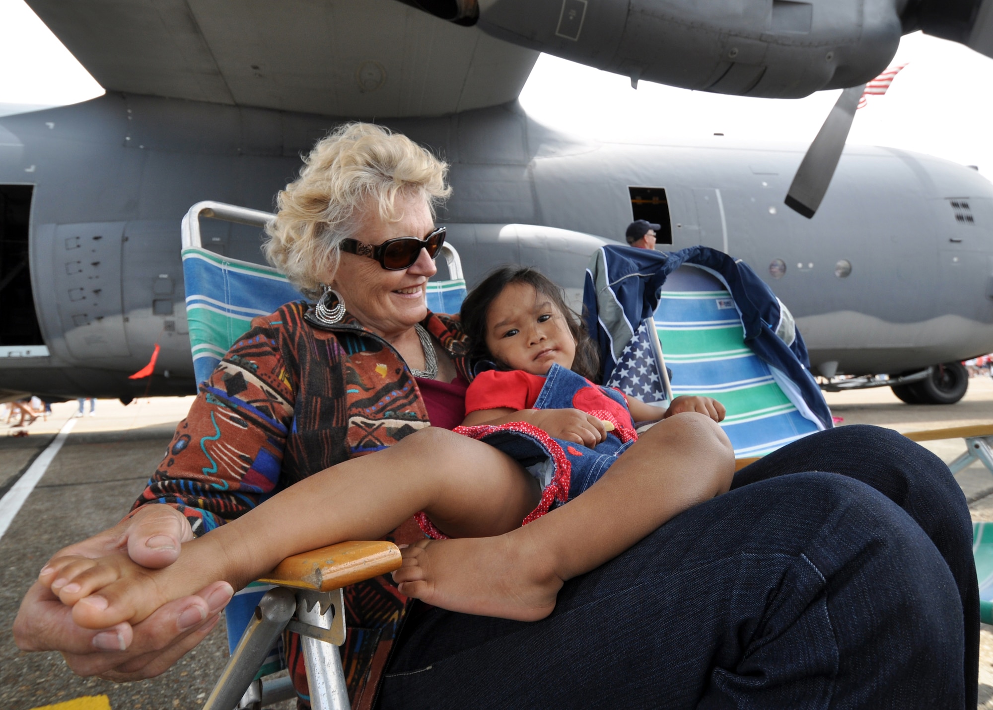 Two airshow patrons take it easy underneath a C-130 April 10 at the Eglin 75th Anniversary Air Show.  More than 125,000 were in attendance at the airshow April 10-11, enjoying a variety of aerial performances and static displays. This was Eglin’s first open house since 2007 and was timed to coincide with the 75th anniversary of the installation. The Thunderbirds, Army Black Daggers, an F-22A Raptor demo and "Tora, Tora, Tora" were some of the highlights of the event. (U.S. Air Force photo/Airman 1st Class Anthony Jennings.) 