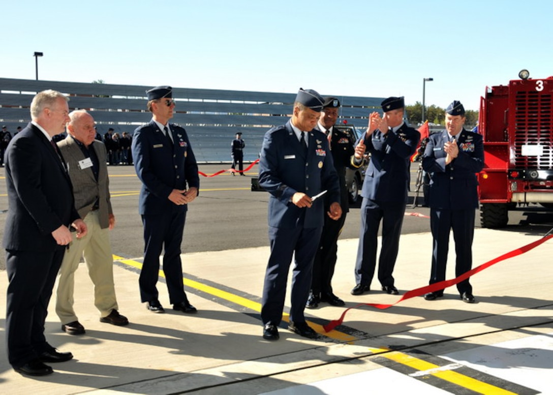Maj. Gen. Garry Dean, 1st Air Force Commander, cuts the ceremonial ribbon officially opening the Air Sovereignty Alert hangars at the 104th Fighter Wing, Massachusetts Air National Guard base in Westfield Massachusetts on April 10, 2010.  The wing officially accepted the alert mission on February 15, 2010, and stands ready to defend the homeland if called upon.  (photograph by Master Sgt. Mark W. Fortin)