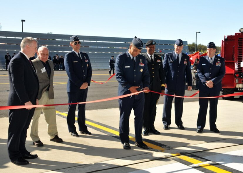 Maj. Gen. Garry Dean, 1st Air Force Commander, cuts the ceremonial ribbon officially opening the Air Sovereignty Alert hangars at the 104th Fighter Wing, Massachusetts Air National Guard base in Westfield Massachusetts on April 10, 2010.  The wing officially accepted the alert mission on February 15, 2010, and stands ready to defend the homeland if called upon.  (photograph by Master Sgt. Mark W. Fortin)