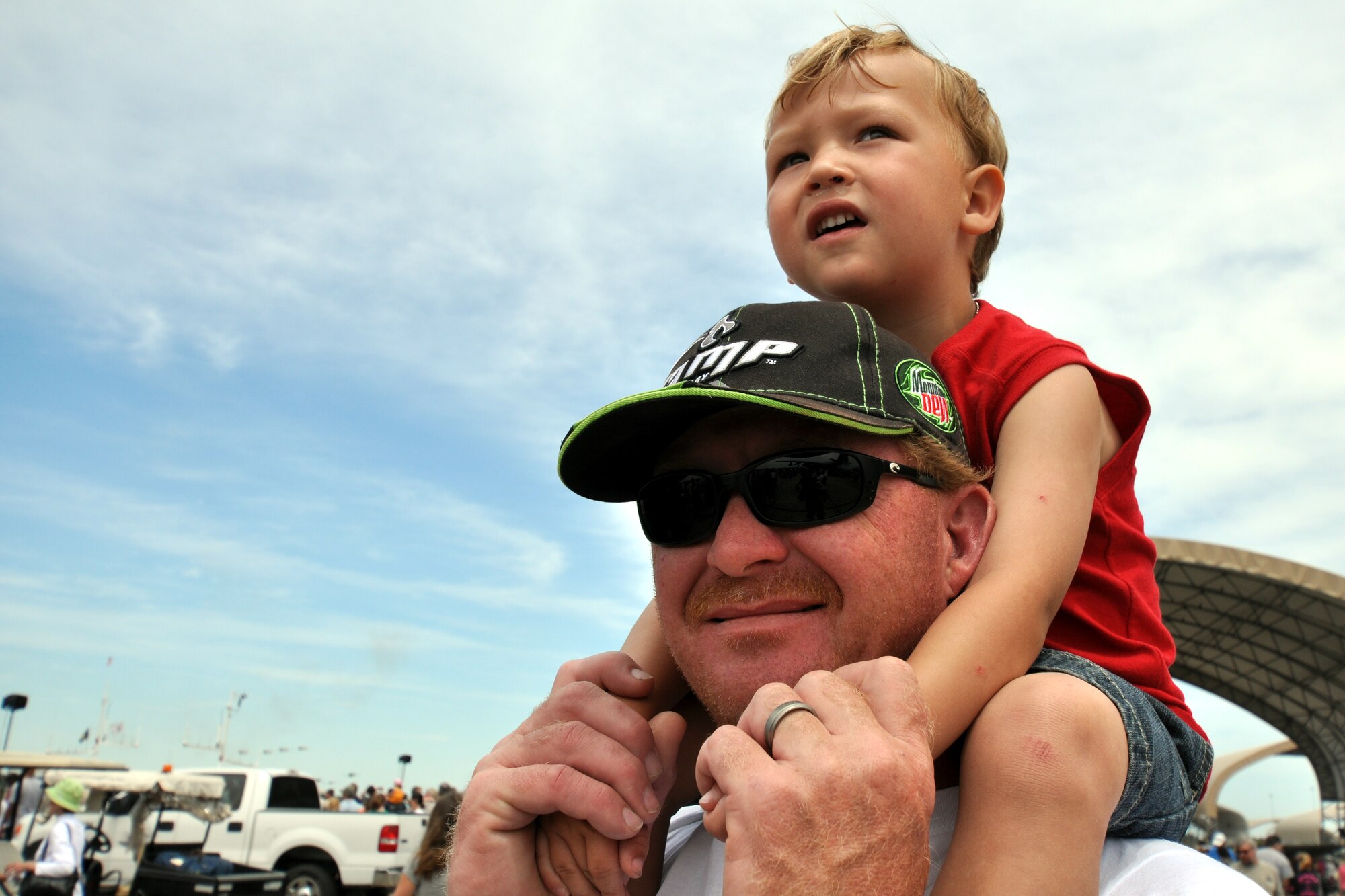 Evan, 2-year-old son of Tech. Sgt Thomas Carter, 1st Special Operations Communications Squadron, watches the show from on high April 10.  More than 125,000 were in attendance during the 75th Anniversary Air Show April 10-11, enjoying a variety of aerial performances and static displays. This was Eglin’s first open house since 2007 and was timed to coincide with the 75th anniversary of the installation. The Thunderbirds, Army Black Daggers, an F-22A Raptor demo and "Tora, Tora, Tora" were some of the highlights of the event. (U.S. Air Force photo/Airman 1st Class Anthony Jennings.) 
