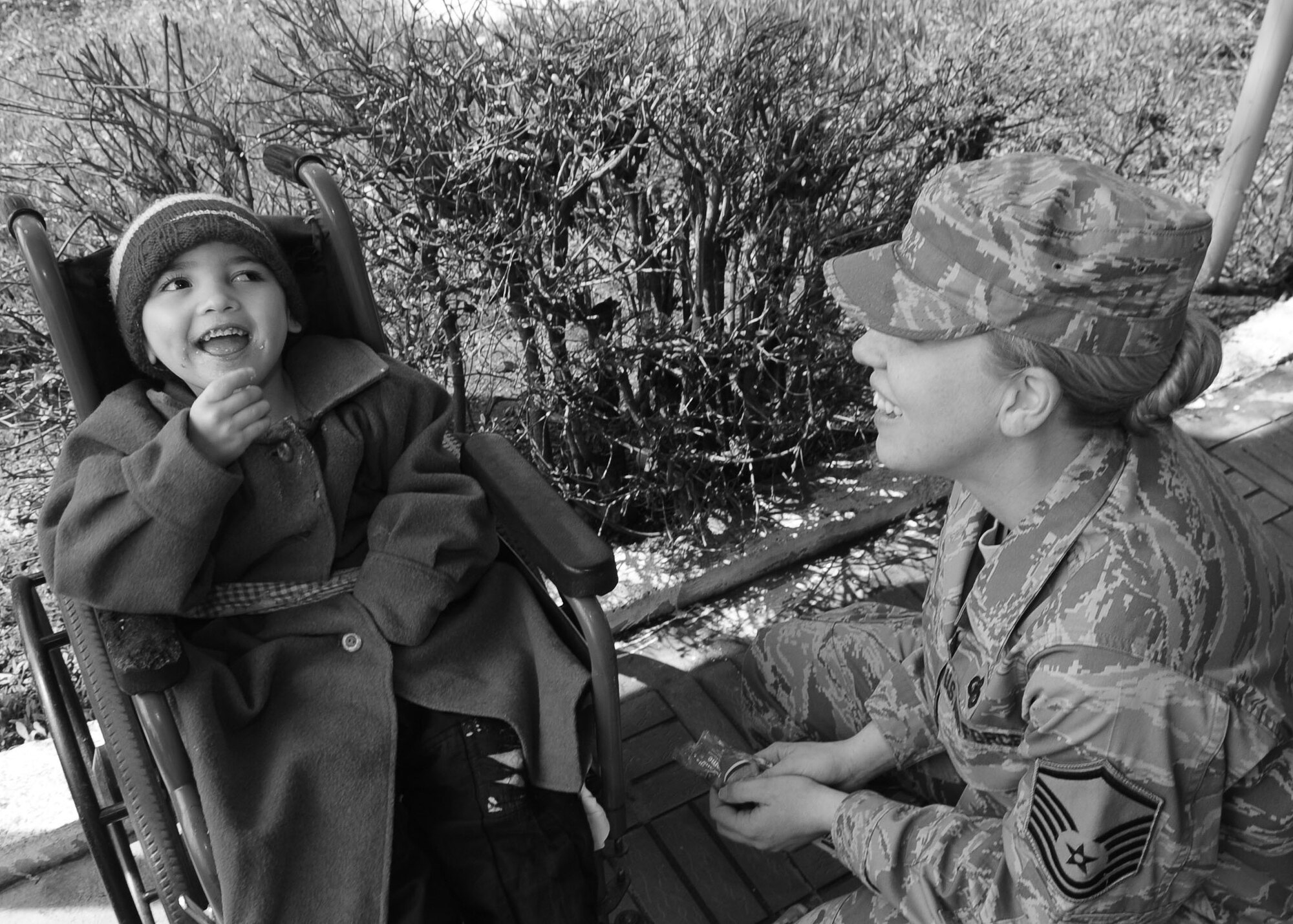 U.S. Air Force Master Sgt. Laurie Boros, a client support administrator for the director of the Transit Center at Manas, Kyrgyzstan, brings a smile to the face of a young child at the Belovodsky Orphanage April 13, 2010. U.S. Airmen from the Transit Center collected 8,000 COM (almost $200) and bought the orphanage basic items including sugar, rice, beans, tea, clothing and other necessities. Some donations were also given by Americans stateside for this and other humanitarian assistance projects in the city and surrounding areas. (U.S. Air Force photo/Senior Airman Nichelle Anderson/released)