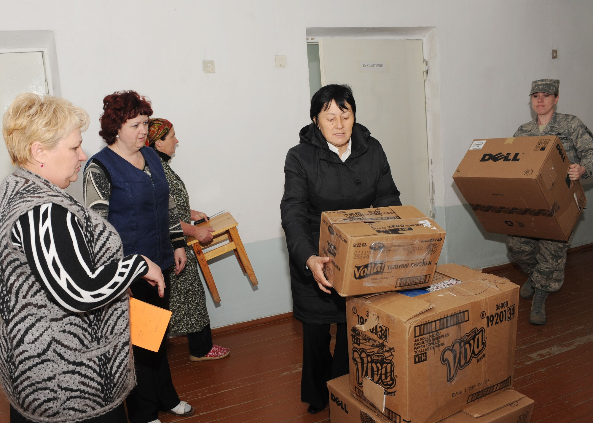 U.S. Air Force Master Sgt. Laurie Boros, a client support administrator for the director of the Transit Center at Manas, Kyrgyzstan, and Valentina Turabekova (center), Kyrgyz advisor, bring boxes of food and clothing to the Belovodsky Orphanage in Bishkek, Kyrgyzstan, April 13, 2010. U.S. Airmen from the Transit Center collected 8,000 COM (almost $200) and bought the orphanage basic items including sugar, rice, beans, tea, clothing, and other necessities. Some donations were also given by Americans stateside for this and other humanitarian assistance projects in the city and surrounding areas. (U.S. Air Force photo/Senior Airman Nichelle Anderson/released)