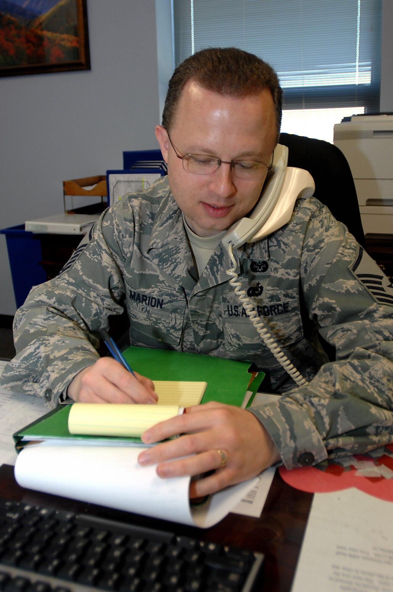 GRISSOM AIR RESERVE BASE, Ind. -- Master Sgt. Wes Marion takes notes while on the phone assisting an Airman. Sergeant Marion, 434th Air Refueling Wing law office superintendant, was recently named Air Force Reserve Command Outstanding Category A Paralegal of the Year 2009. (U.S. Air Force photo/Tech. Sgt. Mark R. W. Orders-Woempner)