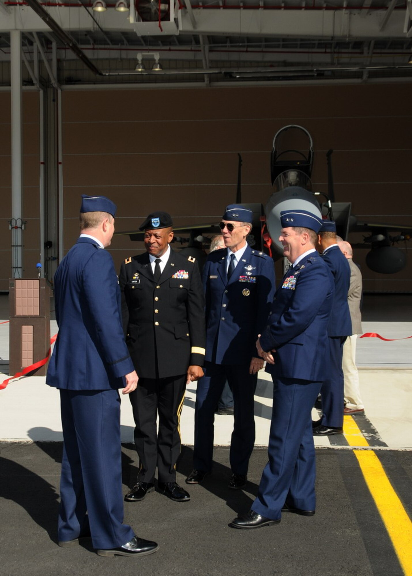 Commanders stand in front of the new Air Sovereignty Alert hangar at the 104th Fighter Wing, Massachusetts Air National Guard base in Westfield Massachusetts on April 10, 2010 just after the official ribbon cutting ceremony.  The wing officially accepted the alert mission on February 15, 2010, and stands ready to defend the homeland if called upon.  (photograph by Senior Master Sgt. Robert J. Sabonis)
