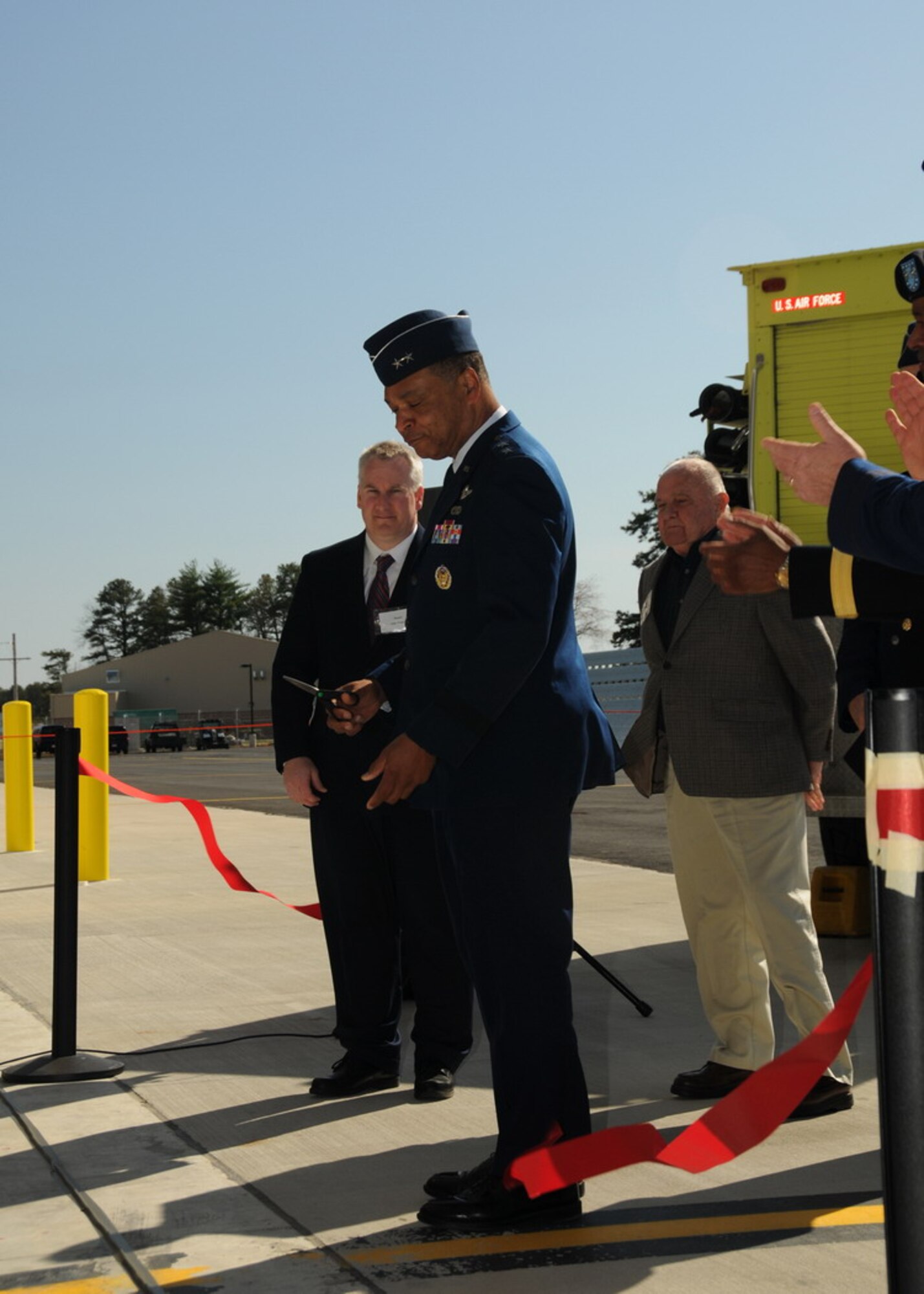 Maj. Gen. Garry Dean, 1st Air Force Commander, cuts the ceremonial ribbon officially opening the Air Sovereignty Alert hangars at the 104th Fighter Wing, Massachusetts Air National Guard base in Westfield Massachusetts on April 10, 2010.  The wing officially accepted the alert mission on February 15, 2010, and stands ready to defend the homeland if called upon.  (photograph by Senior Master Sgt. Robert J. Sabonis)