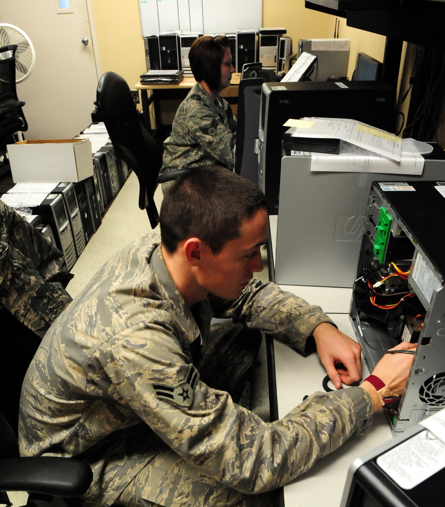 100409-F-6838W-014
SHAW AIR FORCE BASE, S.C. -- Airman First Class Kevin Loggins and Senior Airman Jennifer Britt, repair computer work stations Apr. 9, 2010. The Client Service Center supports customers with a wide variety of computer and communication troubleshooting issues. (U.S. Air Force photo/Airman 1st Class Neil D. Warner)