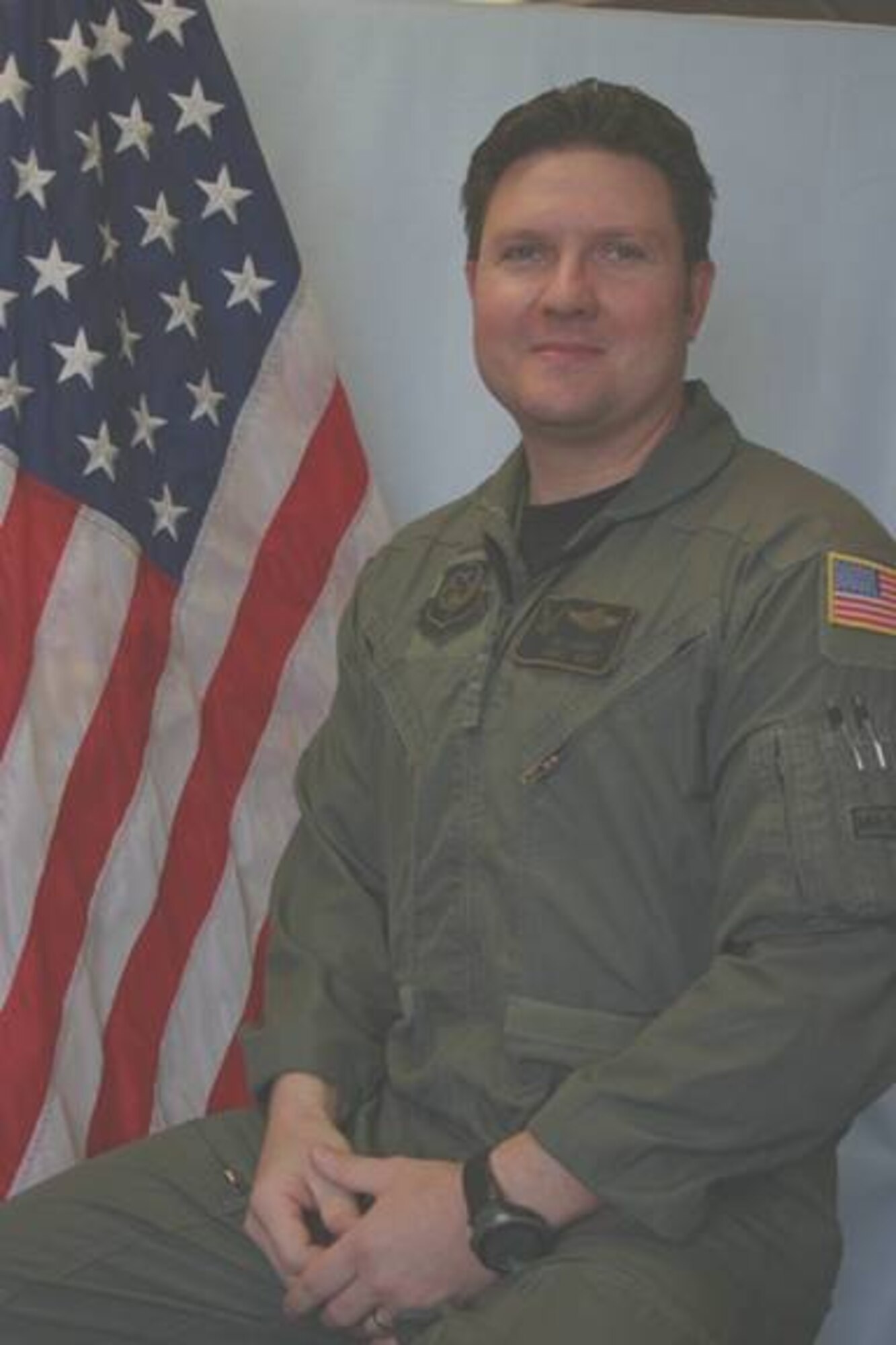Senior Master Sgt. James Lackey, 8th Special Operations Squadron, poses in front of the American flag. Sergeant Lackey died April 8 when his CV-22 Osprey crashed in southern Afghanistan. (Courtesy photo)