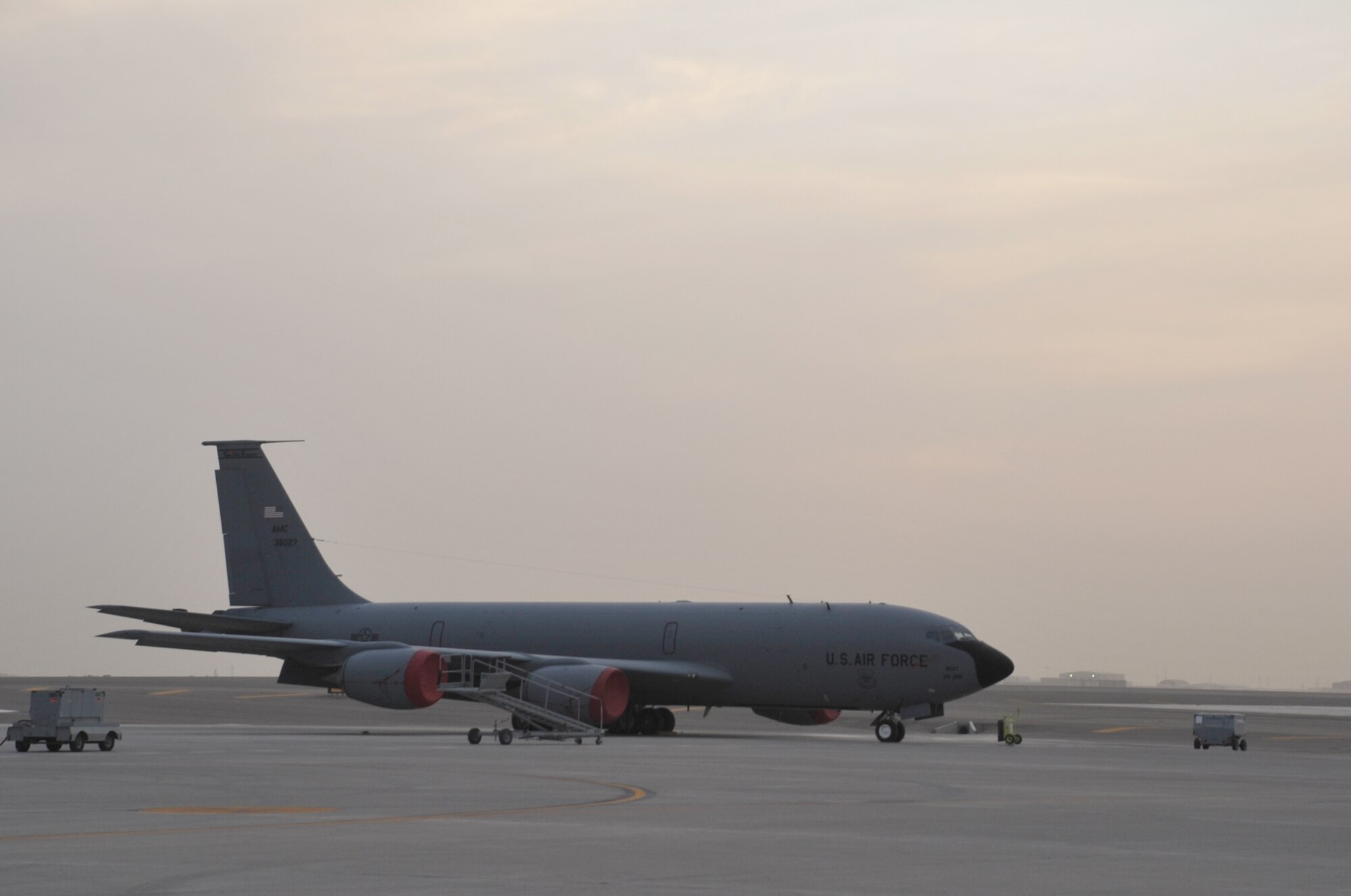 A KC-135R Stratotanker is parked on the flightline as the sun sets April 9, 2010, at a non-disclosed base in Southwest Asia. The KC-135 was forward deployed to support air refueling operations with the 380th Air Expeditionary Wing from the 376th AEW at the Transit Center at Manas, Kyrgystan. The KC-135 is from Grand Forks Air Force Base, N.D. (U.S. Air Force Photo/Master Sgt. Scott T. Sturkol/Released)