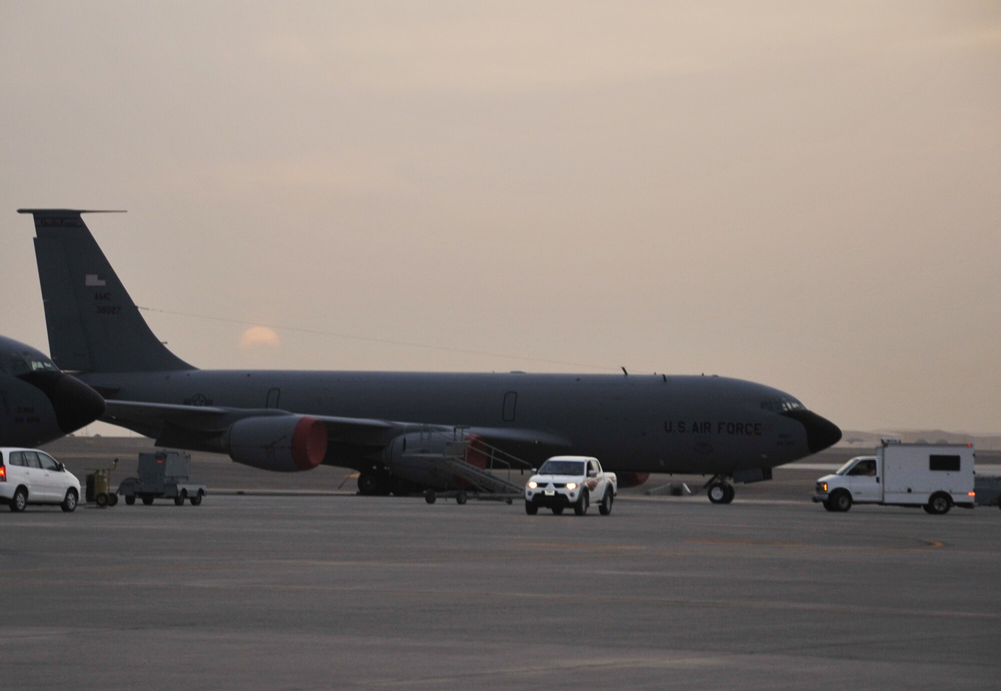 Maintenance Airmen work on a KC-135R Stratotanker as the sun sets April 9, 2010, at a non-disclosed base in Southwest Asia. The KC-135 was forward deployed to support air refueling operations with the 380th Air Expeditionary Wing from the 376th AEW at the Transit Center at Manas, Kyrgystan. The KC-135 is from Grand Forks Air Force Base, N.D. (U.S. Air Force Photo/Master Sgt. Scott T. Sturkol/Released)