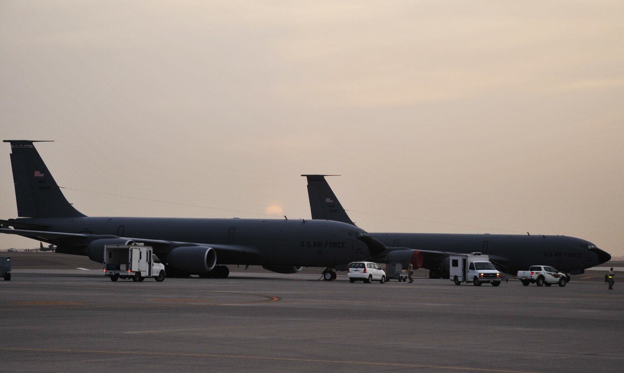 Maintenance Airmen work on KC-135R Stratotankers as the sun sets April 9, 2010, at a non-disclosed base in Southwest Asia. The KC-135 was forward deployed to support air refueling operations with the 380th Air Expeditionary Wing from the 376th AEW at the Transit Center at Manas, Kyrgystan. The KC-135s are from Grand Forks Air Force Base, N.D. (U.S. Air Force Photo/Master Sgt. Scott T. Sturkol/Released)