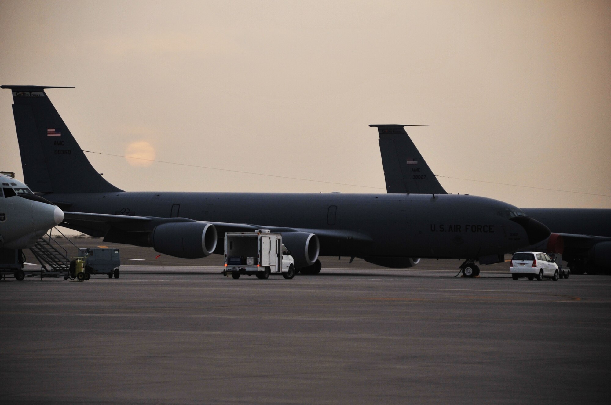 Maintenance Airmen work on a KC-135R Stratotanker as the sun sets April 9, 2010, at a non-disclosed base in Southwest Asia. The KC-135 was forward deployed to support air refueling operations with the 380th Air Expeditionary Wing from the 376th AEW at the Transit Center at Manas, Kyrgystan. The KC-135 is from Grand Forks Air Force Base, N.D. (U.S. Air Force Photo/Master Sgt. Scott T. Sturkol/Released)