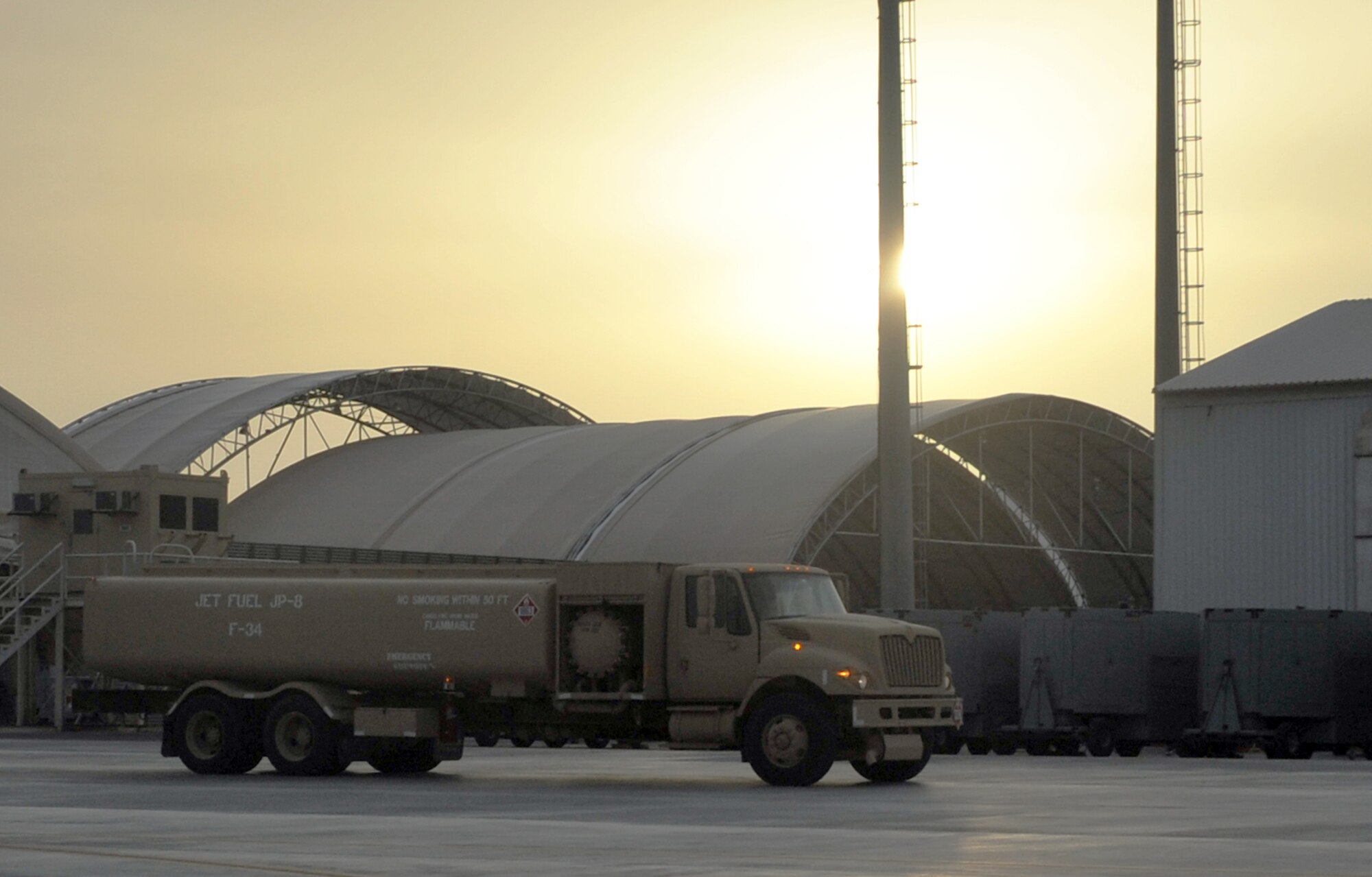An Airman drives an R-11 fuels truck from the 380th Expeditionary Logistics Readiness Squadron fuels management flight as the sun sets at a non-disclosed base in Southwest Asia on April 9, 2010. The fuels management flight remains continuously busy supporting the Air Force's second-largest ground refueling operation in the U.S. Central Command area of responsibility. 380th ELRS fuels Airmen manage more than 40 percent of fuels distribution for the USCENTCOM AOR. The 380th AEW supports operations Iraqi Freedom and Enduring Freedom and the Combined Joint Task Force-Horn of Africa. (U.S. Air Force Photo/Master Sgt. Scott T. Sturkol/Released)