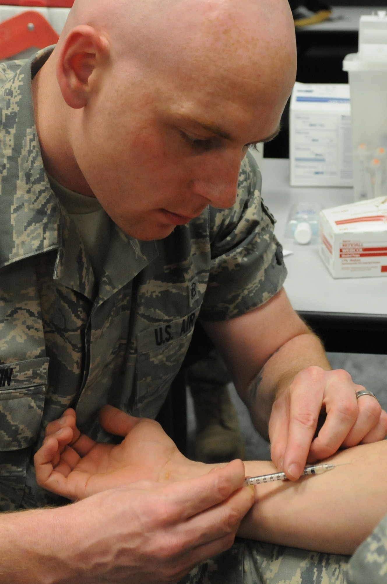Staff Sgt. Christian Baldwin, 31st Medical Operations Squadron immunizations technician, administers tuberculosis shot to an Airman, April 12, as part of his medical clearance paperwork for deployment, Aviano Air Base, Italy. Members from various squadrons were briefed by base agencies, received immunizations, and were issued mandatory equipment during a deployment outprocessing mobility line.
(U.S. Air Force photo/Staff Sgt. Nadine Y. Barclay)