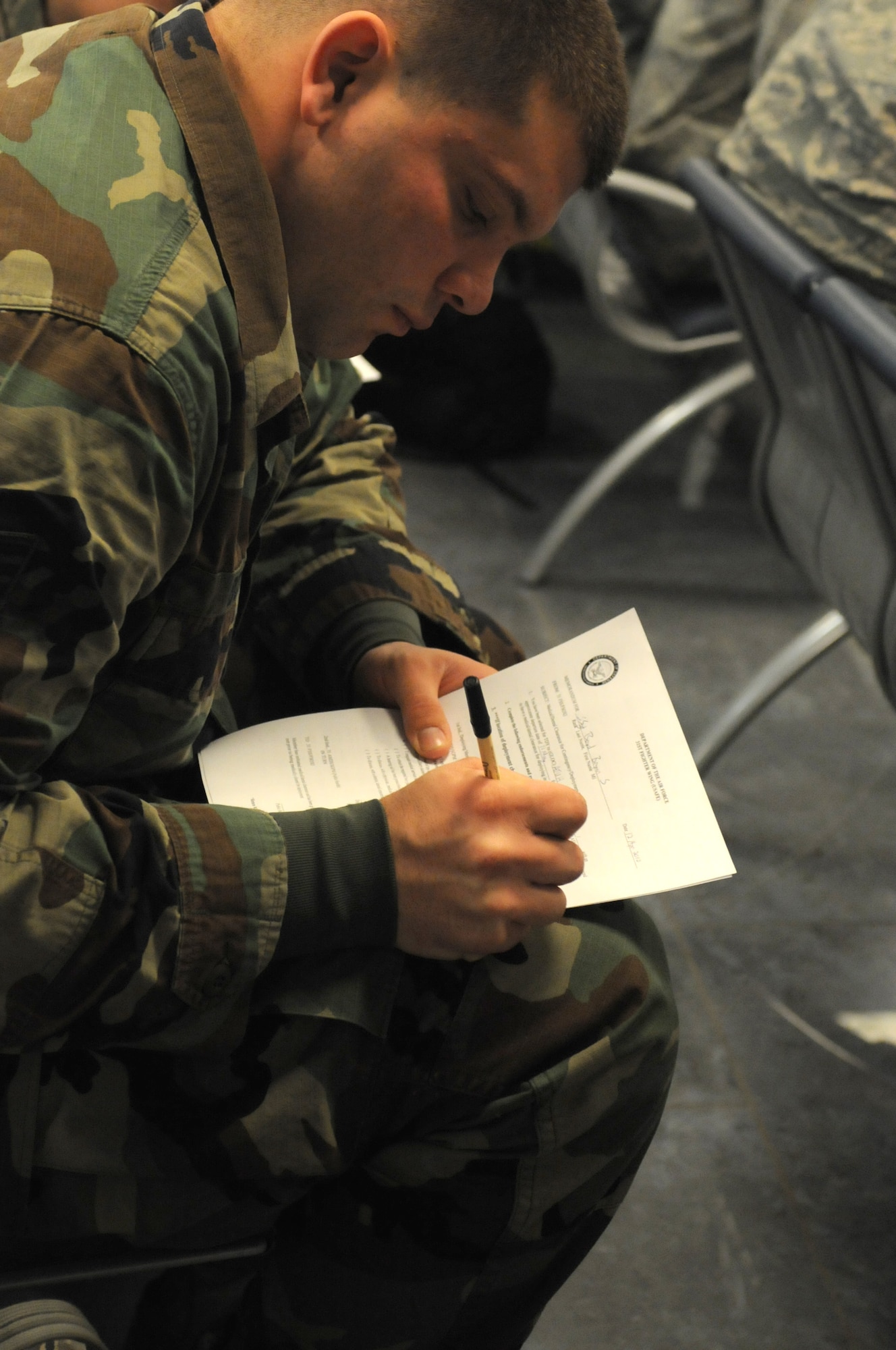 Staff Sgt. Bryan Boyd, 31st Aircraft Maintenance Squadron avionics specialist completes his medical clearance paperwork for deployment during a mass mobility line outprocessing briefing, April 12 at Aviano Air Base, Italy. Sergeant Boyd will be deploying to Southwest Asia.
(U.S. Air Force photo/Staff Sgt. Nadine Y. Barclay)