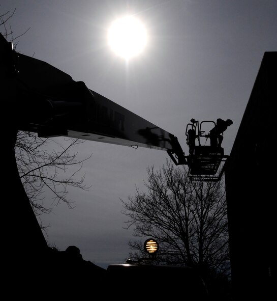 RAF MILDENHALL, England – Jon MacFarlane, 100th Civil Engineer Squadron Structures Shop, is lifted onto the roof of Building 426 April 13, to repair a leak.  With the coming of warmer and drier weather, RAF Mildenhall is seeing several repairs and cleaning projects.  (U.S. Air Force photo/Staff Sgt. Christopher L. Ingersoll)