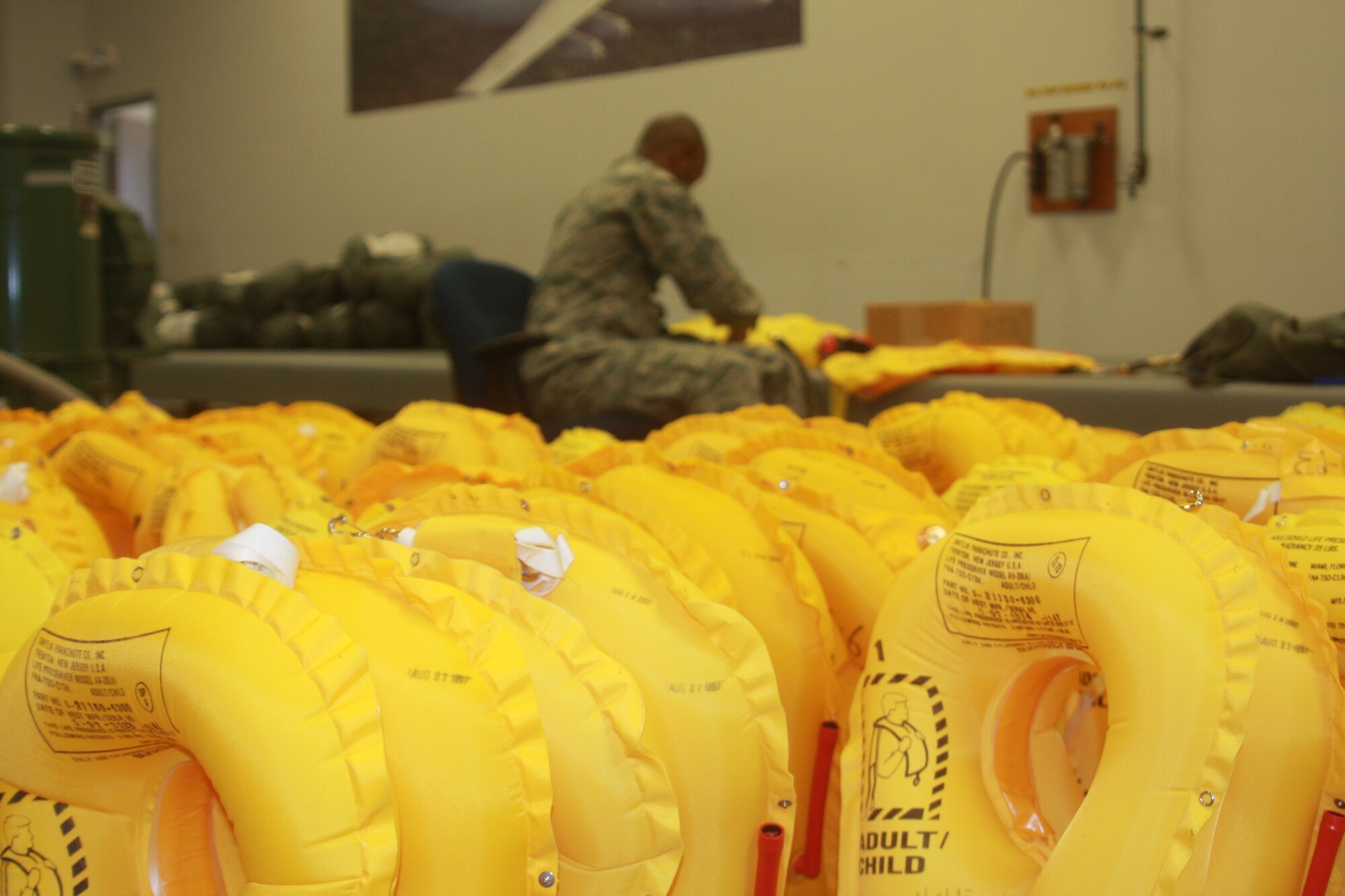 WRIGHT-PATTERSON AIR FORC BASE, Ohio – Senior Airman Aaron Davenport, 445th Operational Support Squadron, aircrew flight equipment technician, inspects life preserver units for possible leaks and tears March 28 as part of his routine equipment inspection. (U.S. Air Force photo/Senior Airman Mikhail Berlin) 