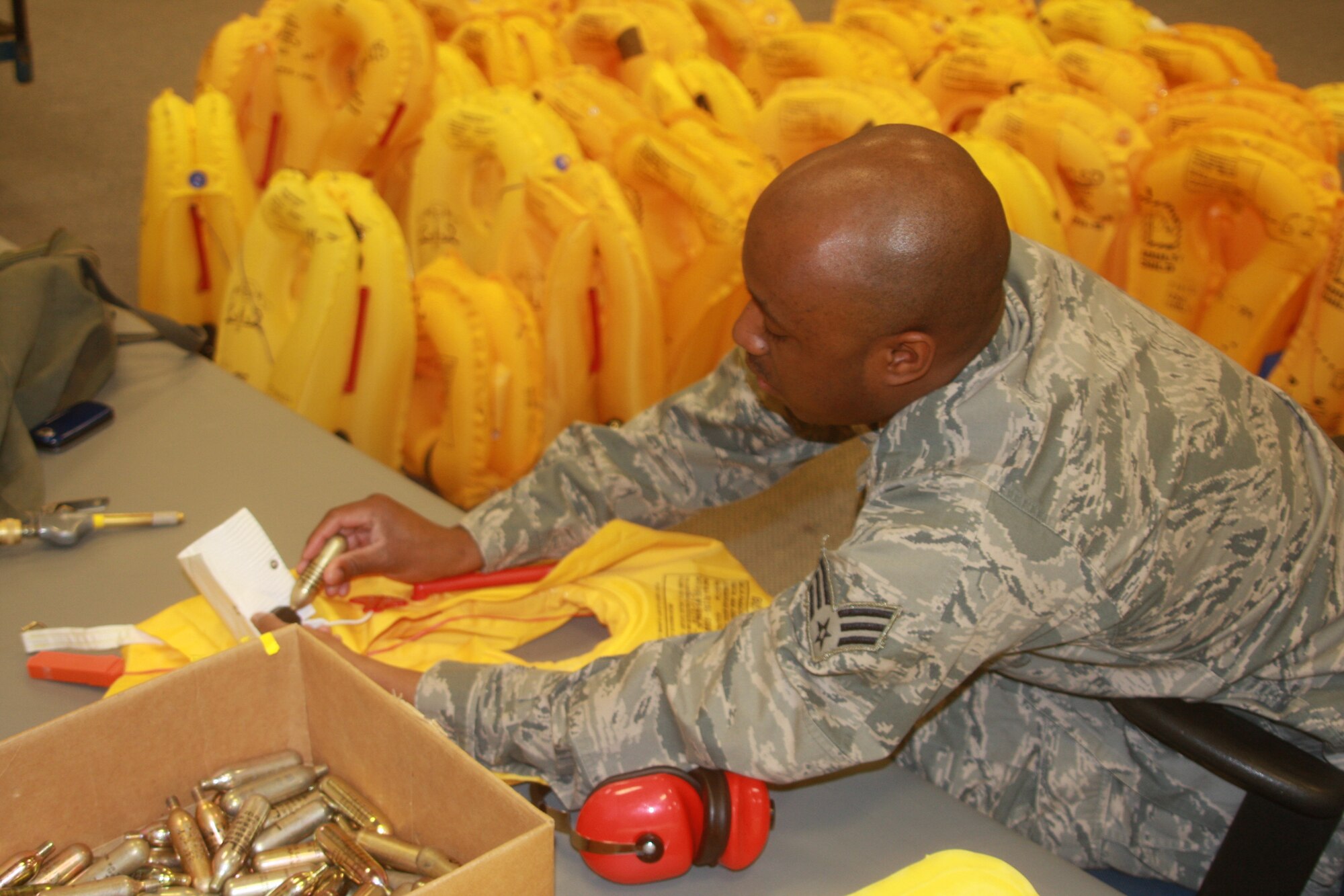 WRIGHT-PATTERSON AIR FORC BASE, Ohio – Senior Airman Aaron Davenport, 445th Operational Support Squadron, aircrew flight equipment technician, inspects life preserver units for possible leaks and tears March 28 as part of his routine equipment inspection. (U.S. Air Force photo/Senior Airman Mikhail Berlin) 