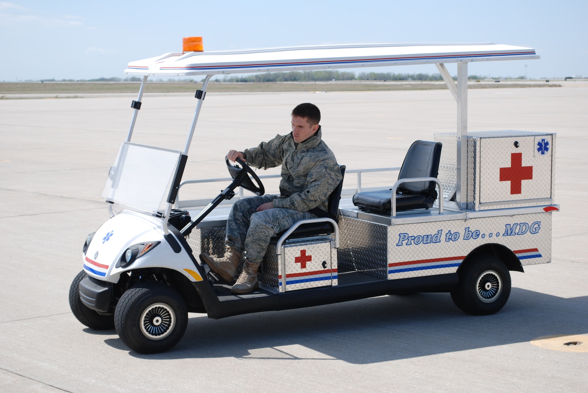 Airman 1st Class Matthew Santino, 22nd Aerospace Medicine Squadron, drives a patient transport vehicle to a C-130 Hercules as part of a National Disaster Medical System Activation exercise April 8, 2010, McConnell Air Force Base, Kan. During a real disaster, McConnell would serve as a reception point for regional medical evacuation. (U.S. Air Force photo/2nd Lt. Nicholas Mercurio) 