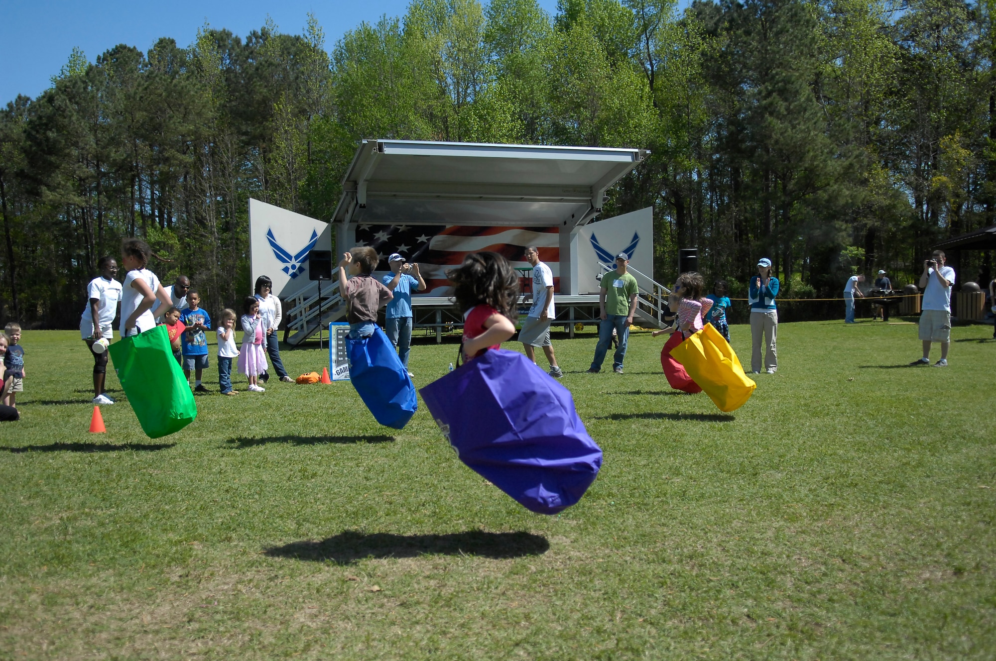 Pope children participate in a potato sack race at Pope’s Annual Spring Fling and Furry Friends Walk at Pope April 10. Along with the walk, the day included several events such as a bouncy castle, arts and crafts, family kickball and a potato sack race. All members of the family were invited, pets included. (U.S. Air Force photo by 2nd Lt. Cammie Quinn)