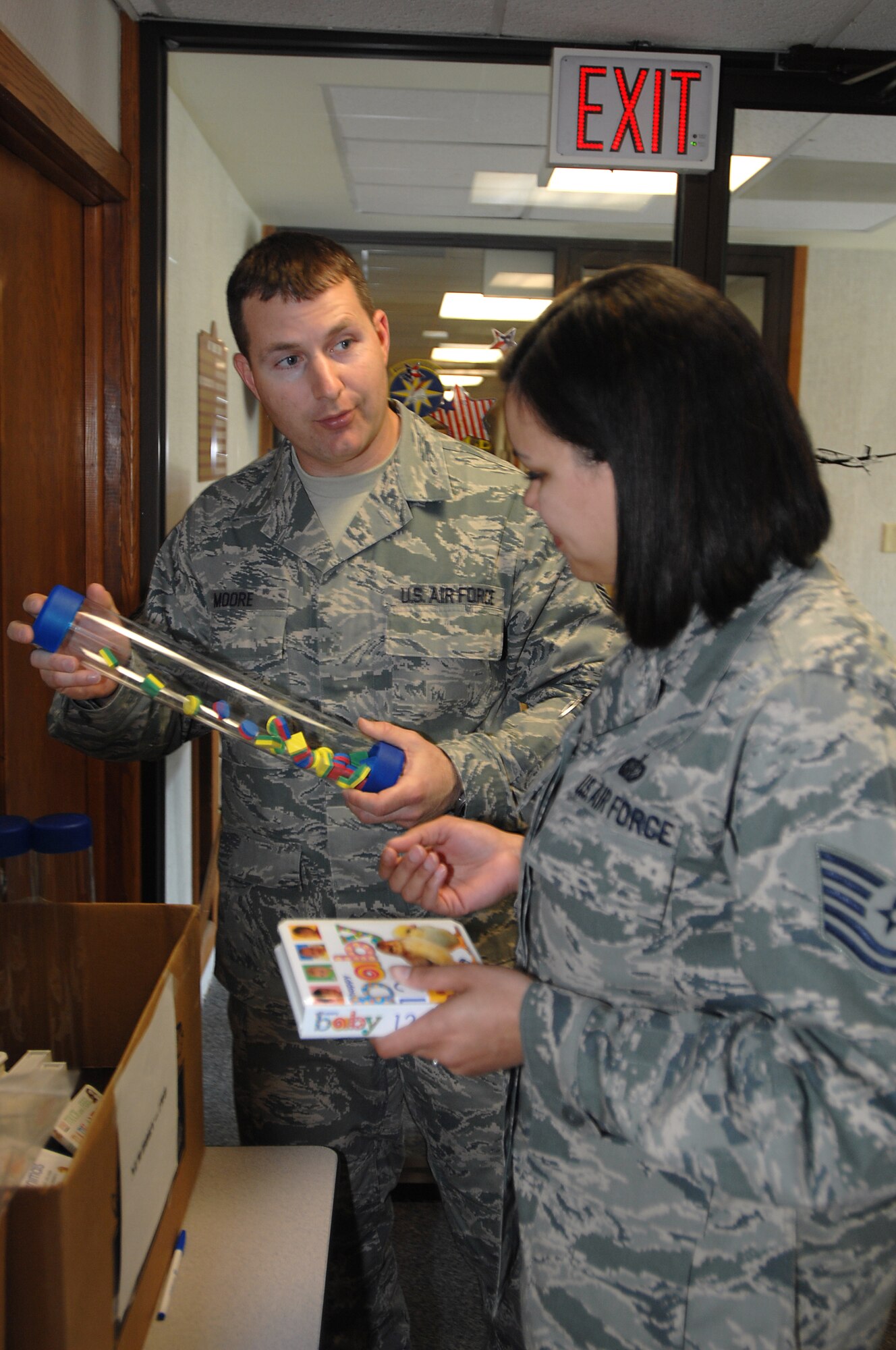 GRISSOM AIR RESERVE BASE, Ind. -- Master Sgt. Nathan Moore, 434th Airman and Family Readiness noncommissioned officer in charge, gives Tech. Sgt. Tanisha Siliva a choice of craft projects for her children during the April unit training assembly here. April is Month of the Military Child and the AFR office provided servicemembers with craft projects, books and popcorn for their children. Sergeant Silva is a services specialist with the 434th Services Flight. (U.S. Air Force photo/Tech. Sgt. Mark R. W. Orders-Woempner)