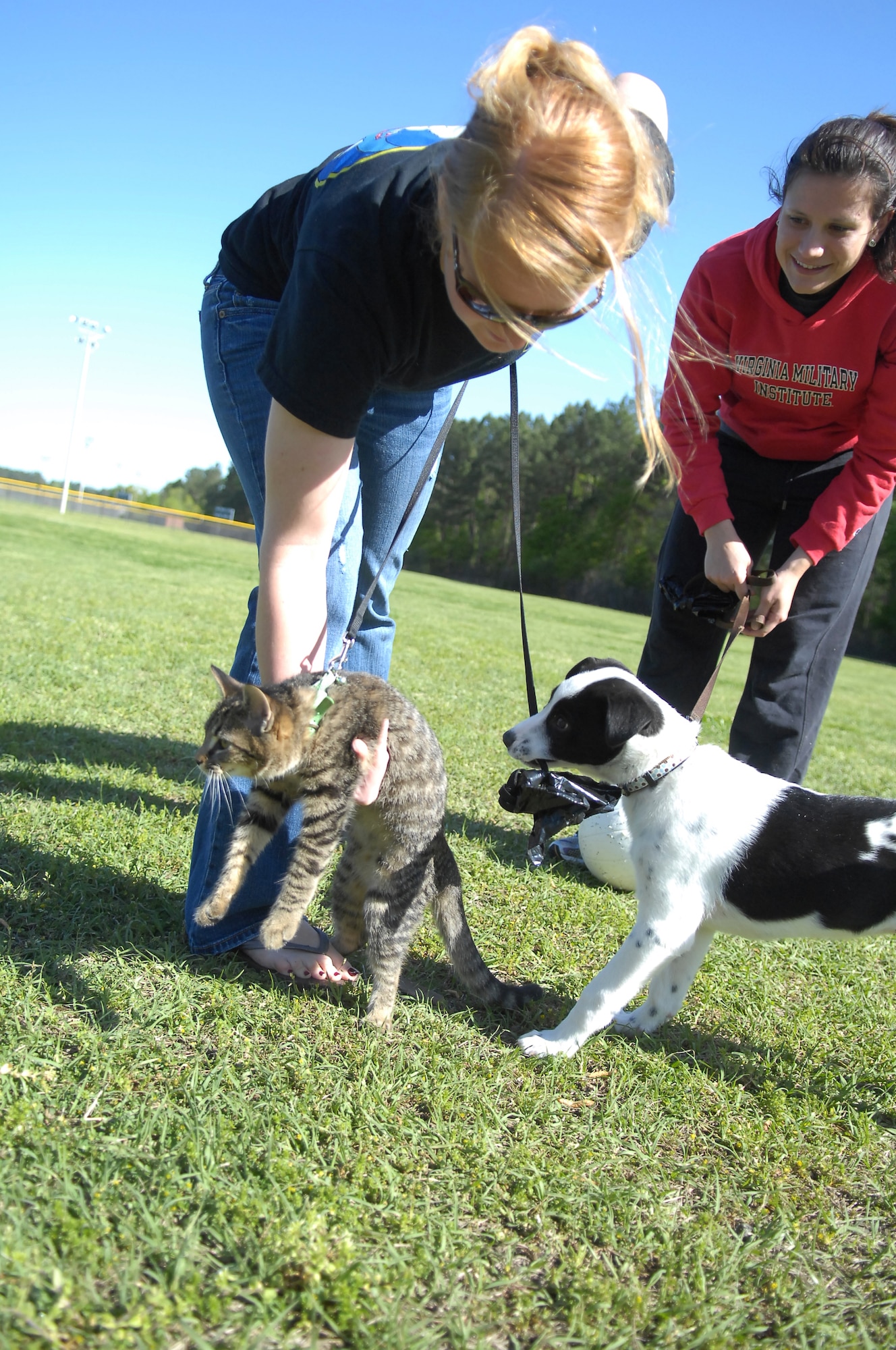 2nd Lts. Megan Grooms and Katie Bopp, 43rd Force Support Squadron, participate in Pope’s annual Spring Fling and Furry Friends Walk at Pope’s Woodland Park April 10. Lieutenant Grooms’ cat, Fiona walked with Lieutenant Bopp’s dog, Liberty Bell during the walk from Woodland Park to the Manchester Gate. Along with the walk, the day included several events such as a bouncy castle, arts and crafts, family kickball and a potato sack race. All members of the family were invited, pets included. (U.S. Air Force photo by 2nd Lt. Cammie Quinn)
