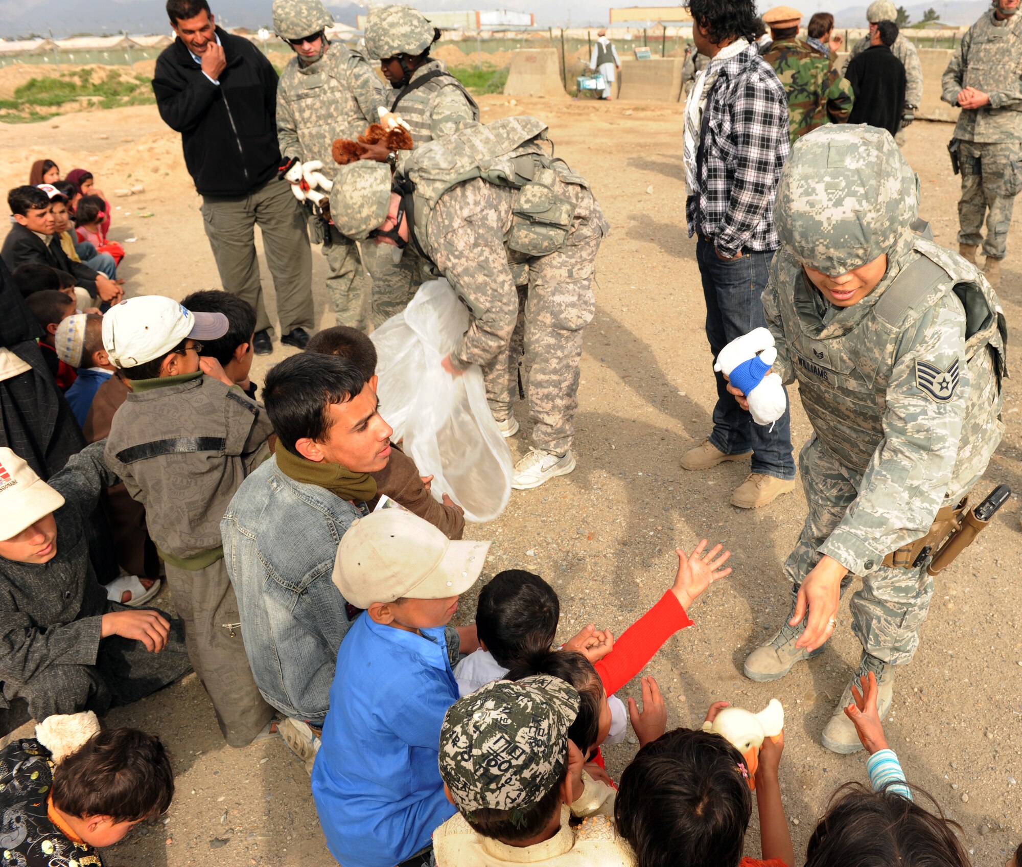 U.S. military members donate humanitarian aid to local residents during a recent Operation Care humanitarian aid mission at Bagram Airfield, Afghanistan. The Operation Care team donated clothing, shoes and other items to residents in need. (U.S. Air Force photo by/ Staff Sgt. Richard Williams)