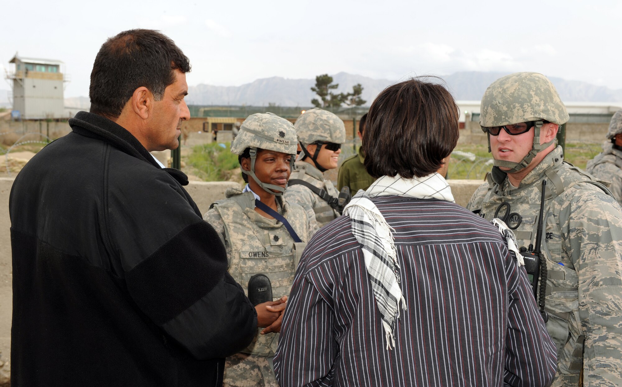 U.S. Army Lt. Col. Terry Owens, 30th Medical Command and Operation Care president, and U.S. Air Force Capt. Jason Williams, 455th Expeditionary Security Forces, discuss item distribution with a village elder and an interpreter during a recent Operation Care humanitarian aid mission at Bagram Airfield, Afghanistan. Colonel Owens is deployed from Heidelberg, Germany and is a Hampton, Va. native. Captain Williams is deployed from Keesler Air Force Base, Miss., and is an Asheboro, N.C. native.  
