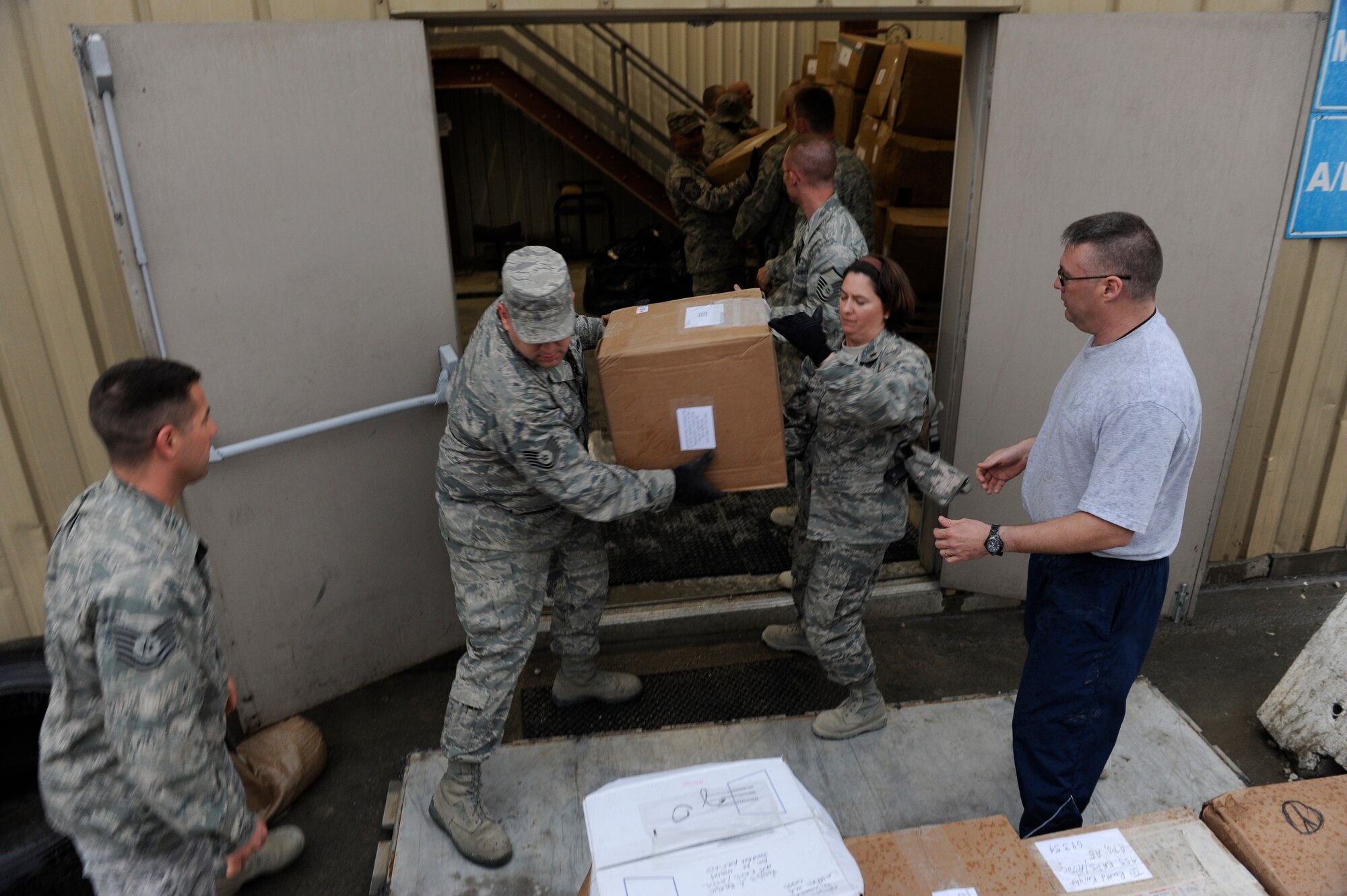 Members of the 455th Expeditionary Aerial Port Squadron load a pallet with more than 1,100 pounds of shoes donated by the Marblehead, Mass. Public School System for use by Operation Care, Afghanistan. The program offers humanitarian assistance to local civilians in remote areas of Afghanistan. (U.S. Air Force photo by/ Tech. Sgt. Jeromy K. Cross)